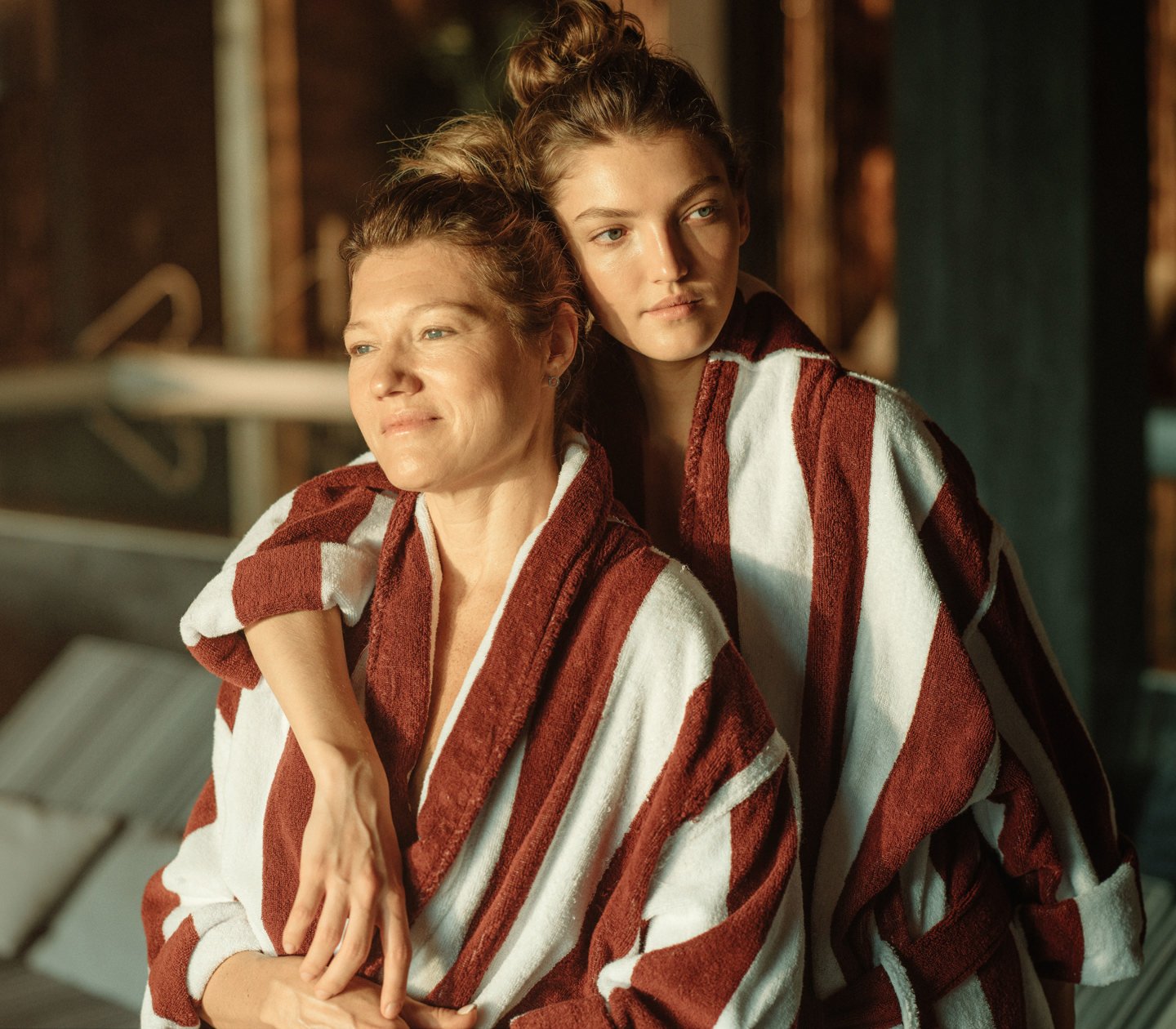 Mother and daughter sitting in bathrobes