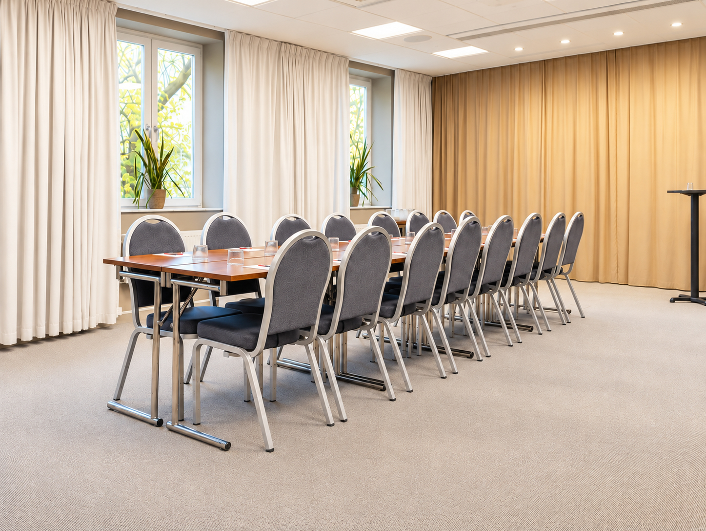 White conference room with round tables and chairs