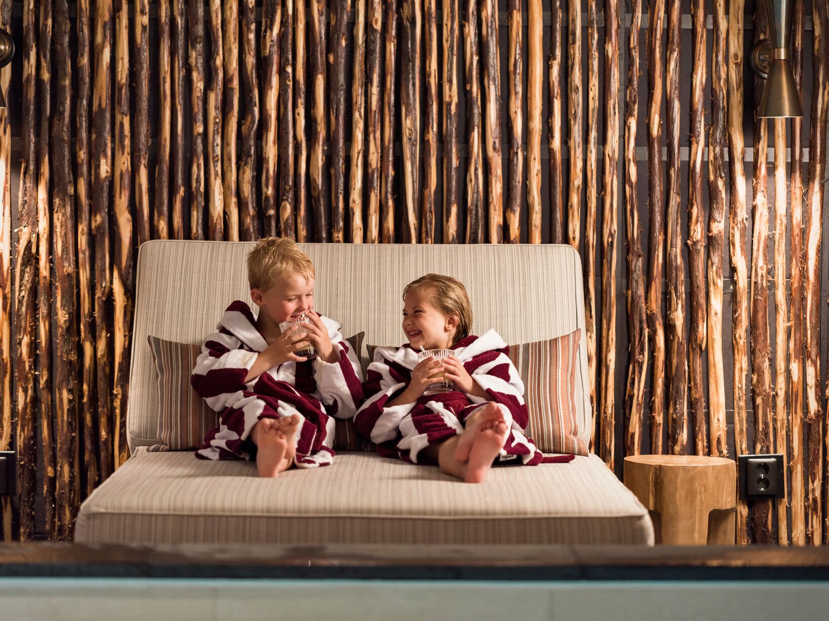 A woman and child snuggling and enjoying a beverage