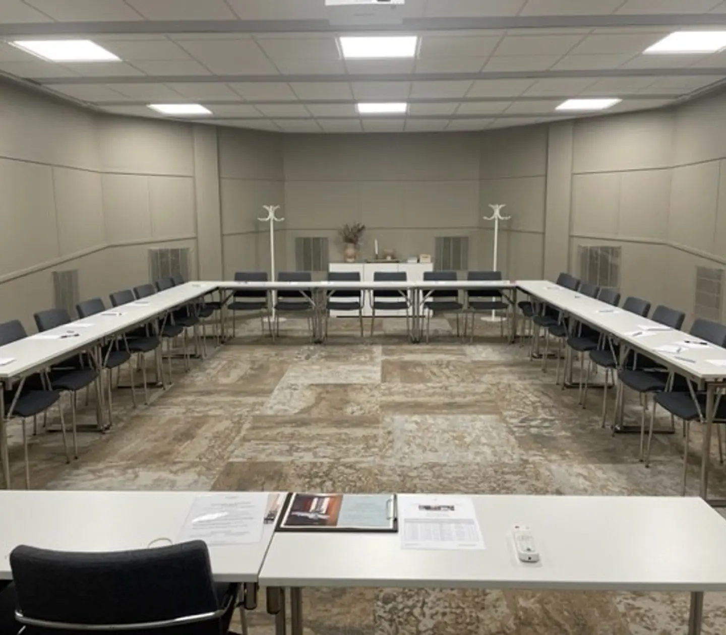 Conference room with lined up chairs and gray walls