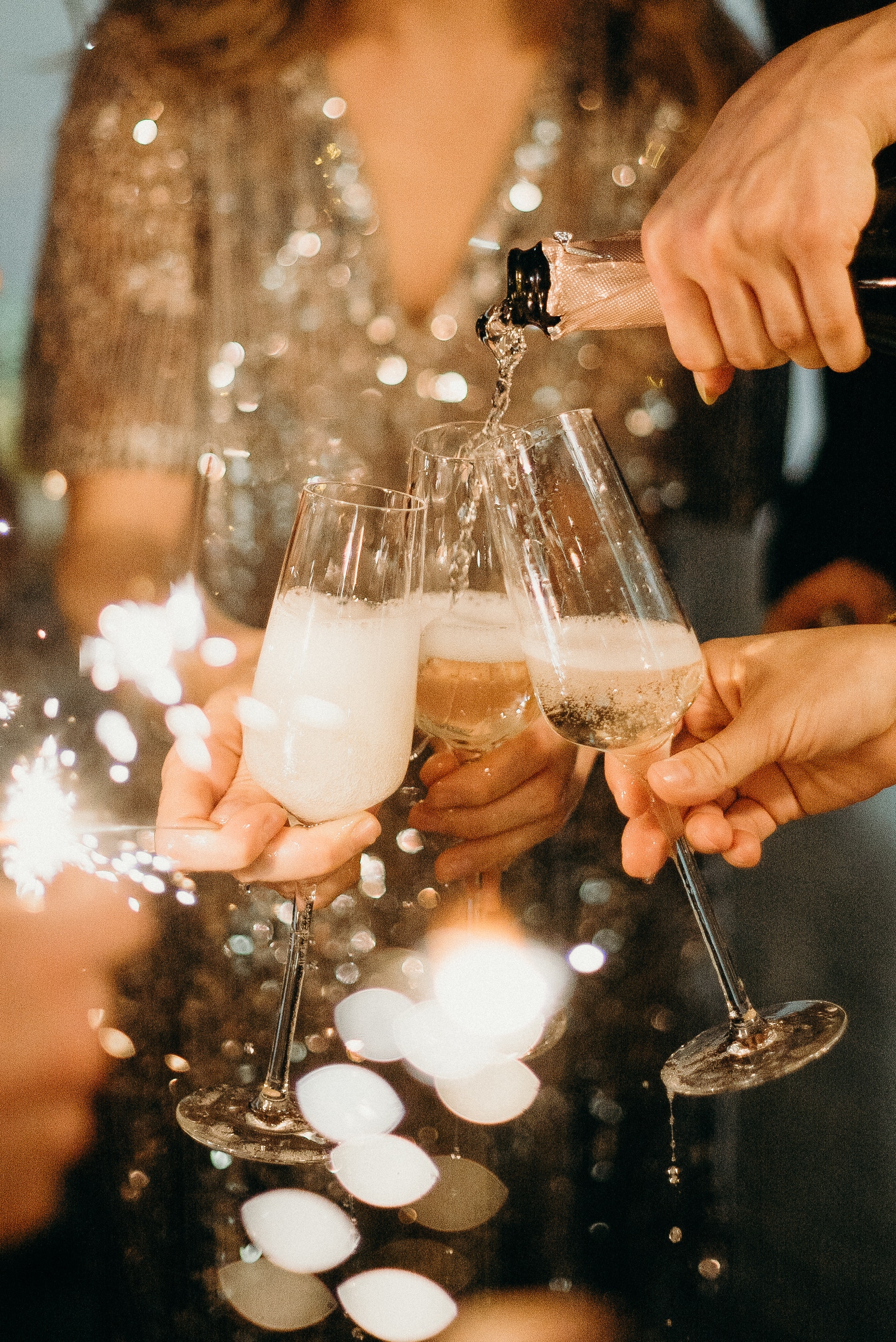 Hands toasting with champagne glasses