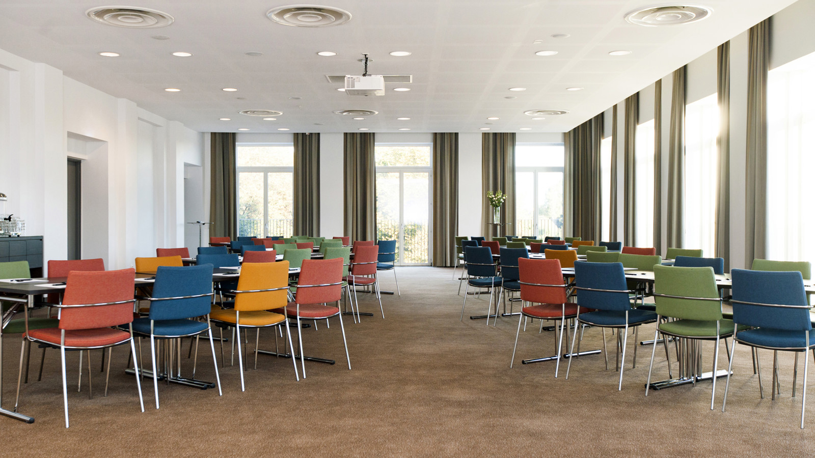 large room with tables and colourful chairs