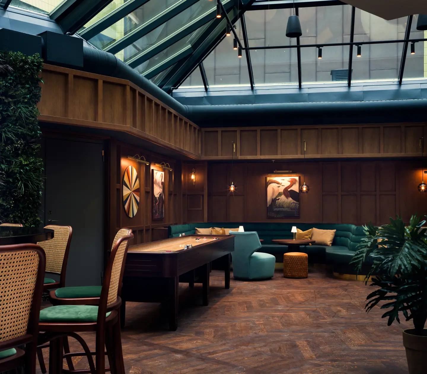Elegant indoor lounge with natural light from skylights, comfortable seating, and stylish interior design.