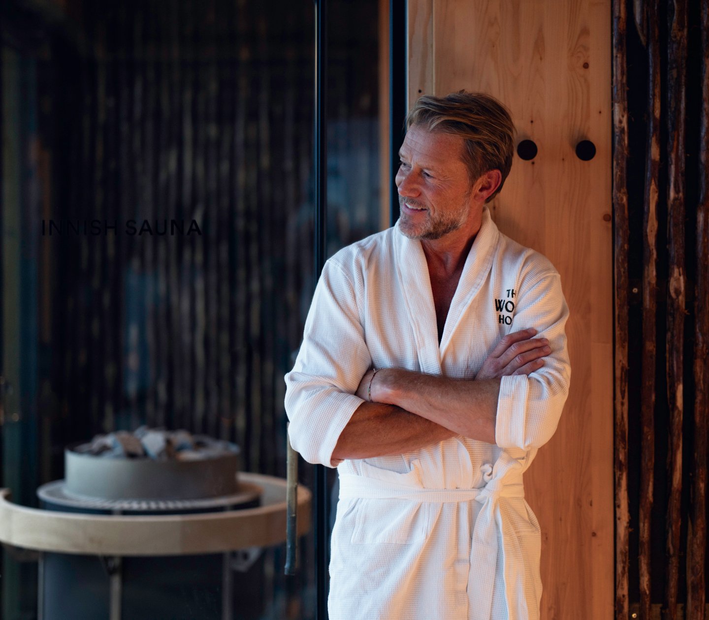 Man in bathrobe outside sauna