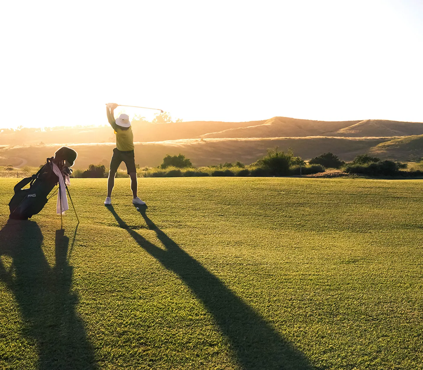 Golfclubs with a golf course in the background