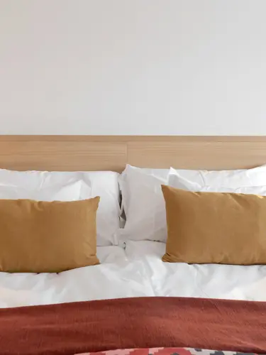 Hotel bed with yellow pillows