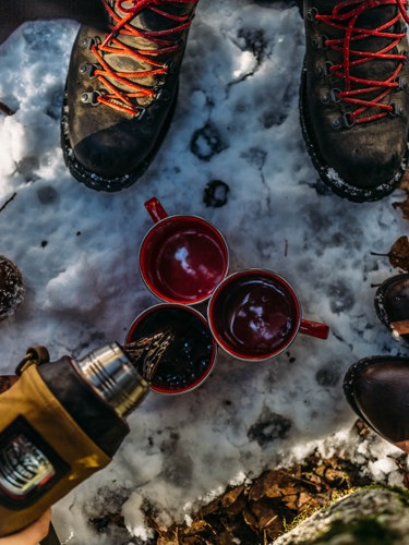 Coffee and shoes in a winter landscape