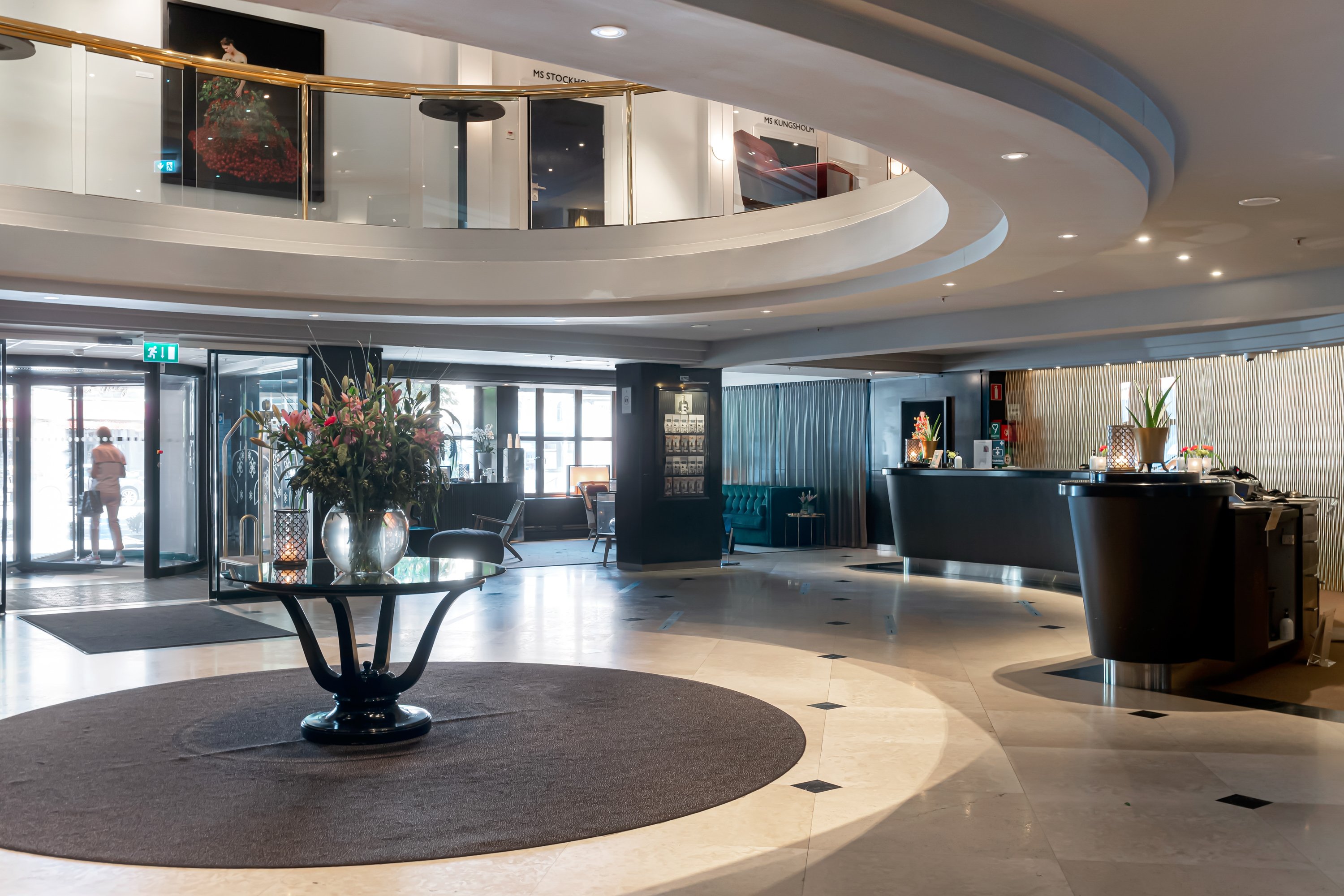 Hotel lobby with reception desks and open roof