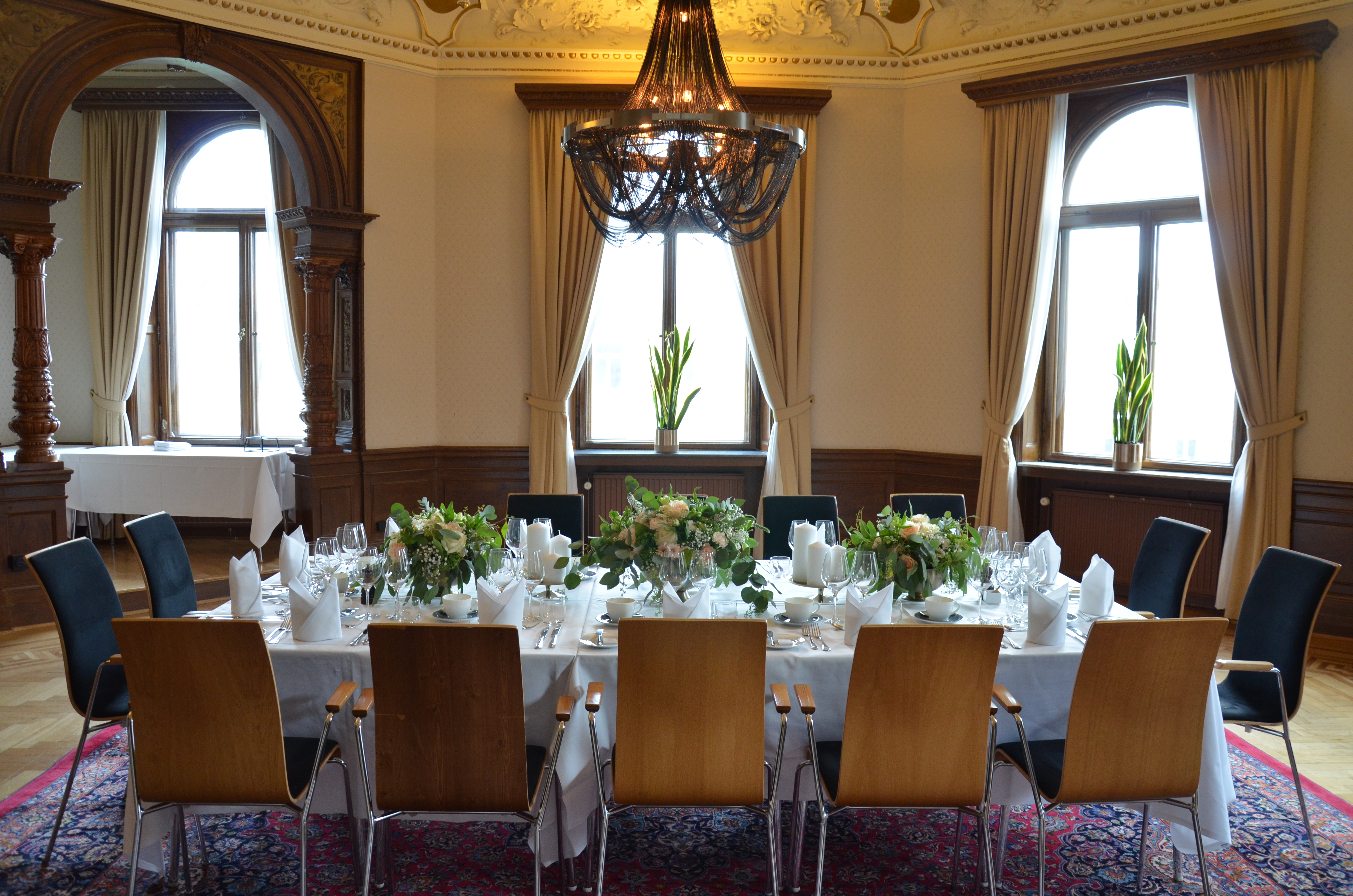 Large wedding venue with several tables and chairs in groups.