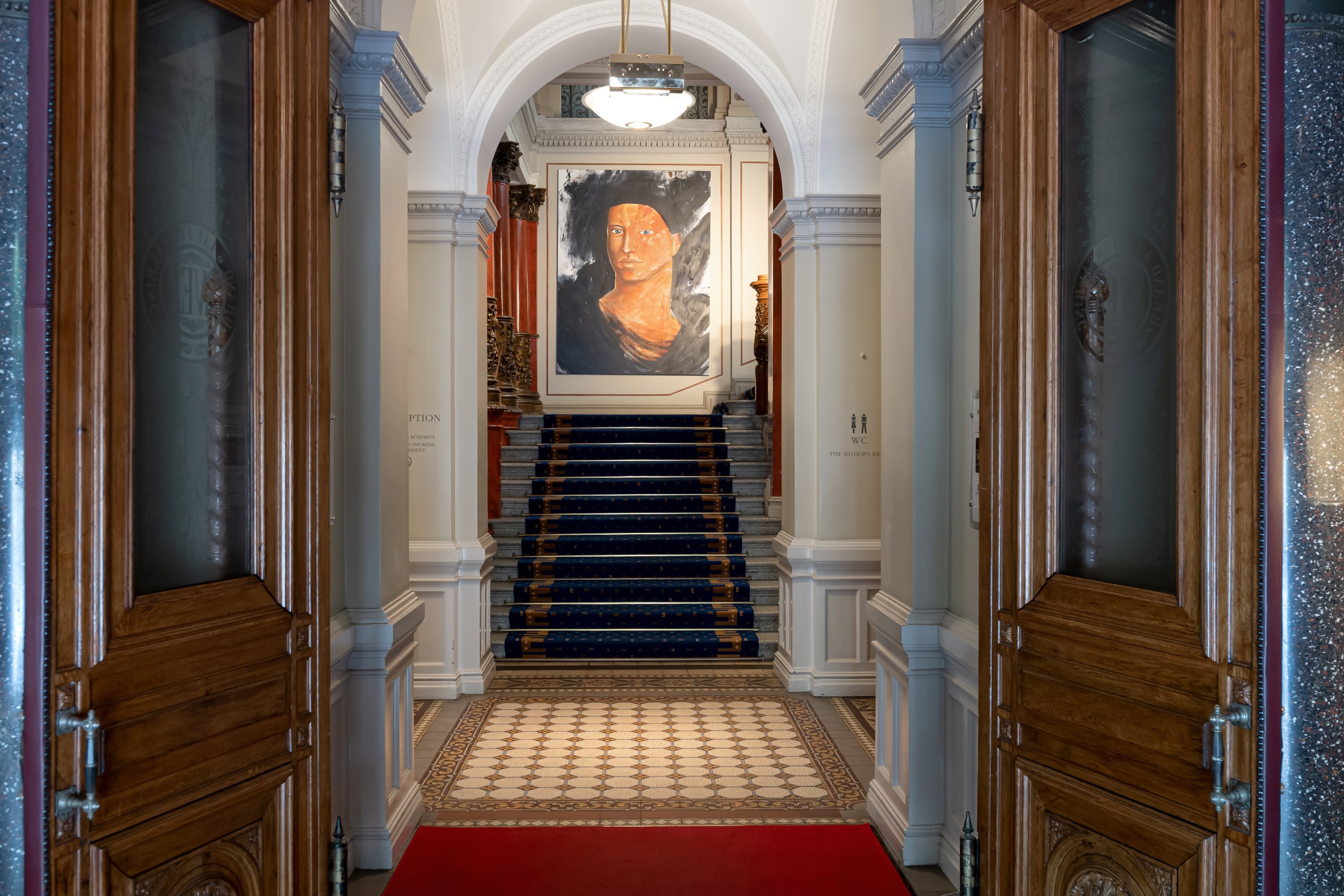 Hotel environment with stairs and painting of a face