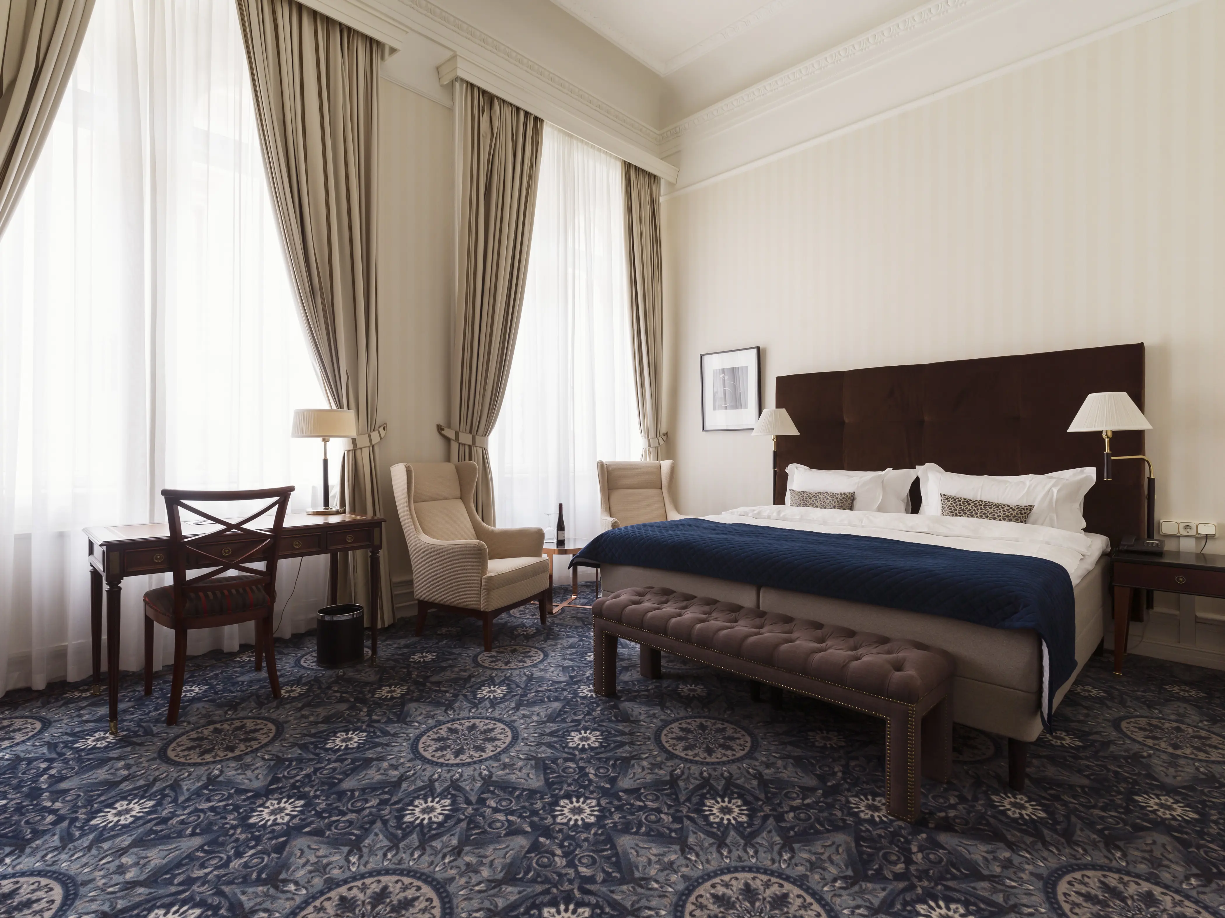 Cozy suite with wall-to-wall carpet, double bed, and window.