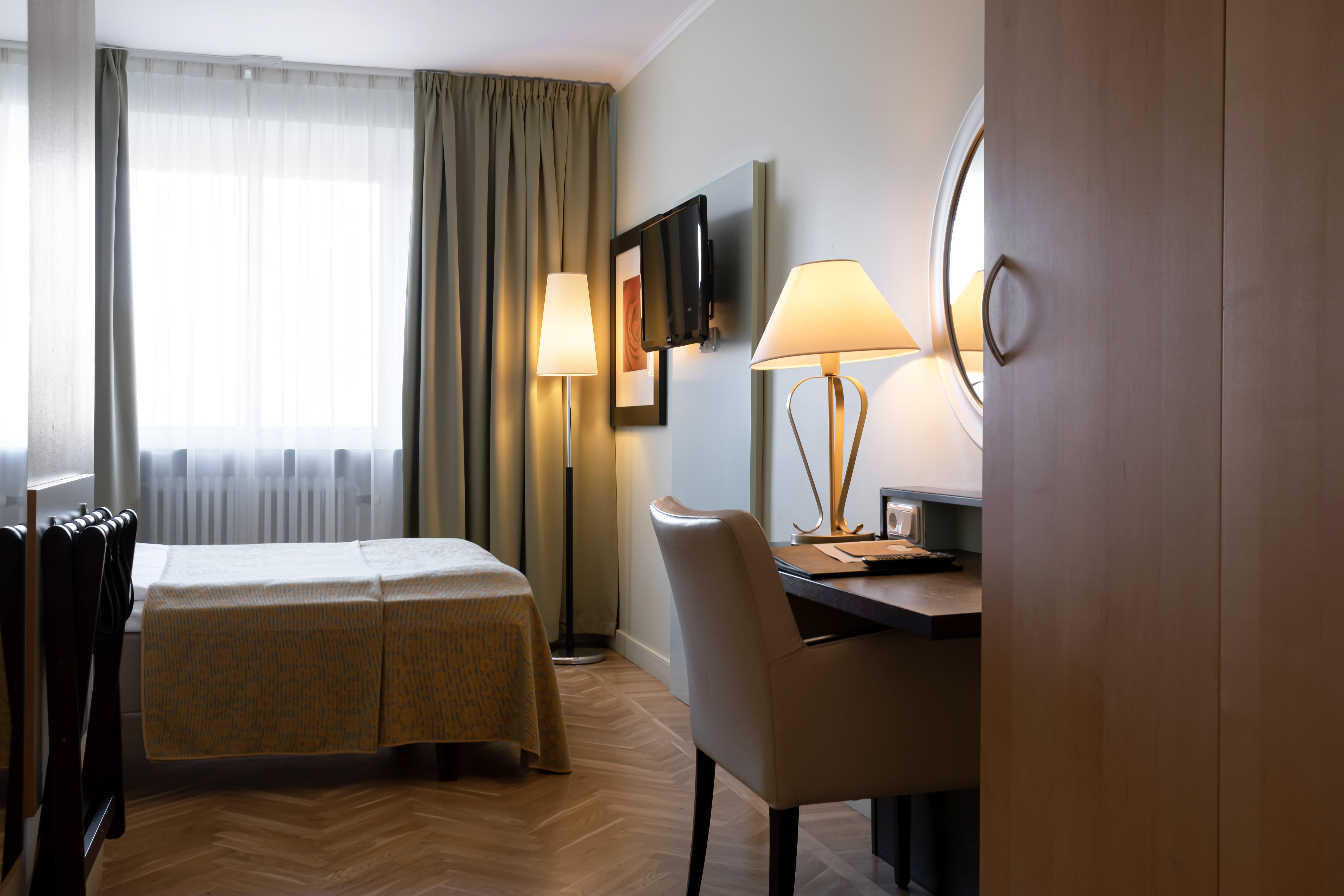 Hotel room with bed, desk and window