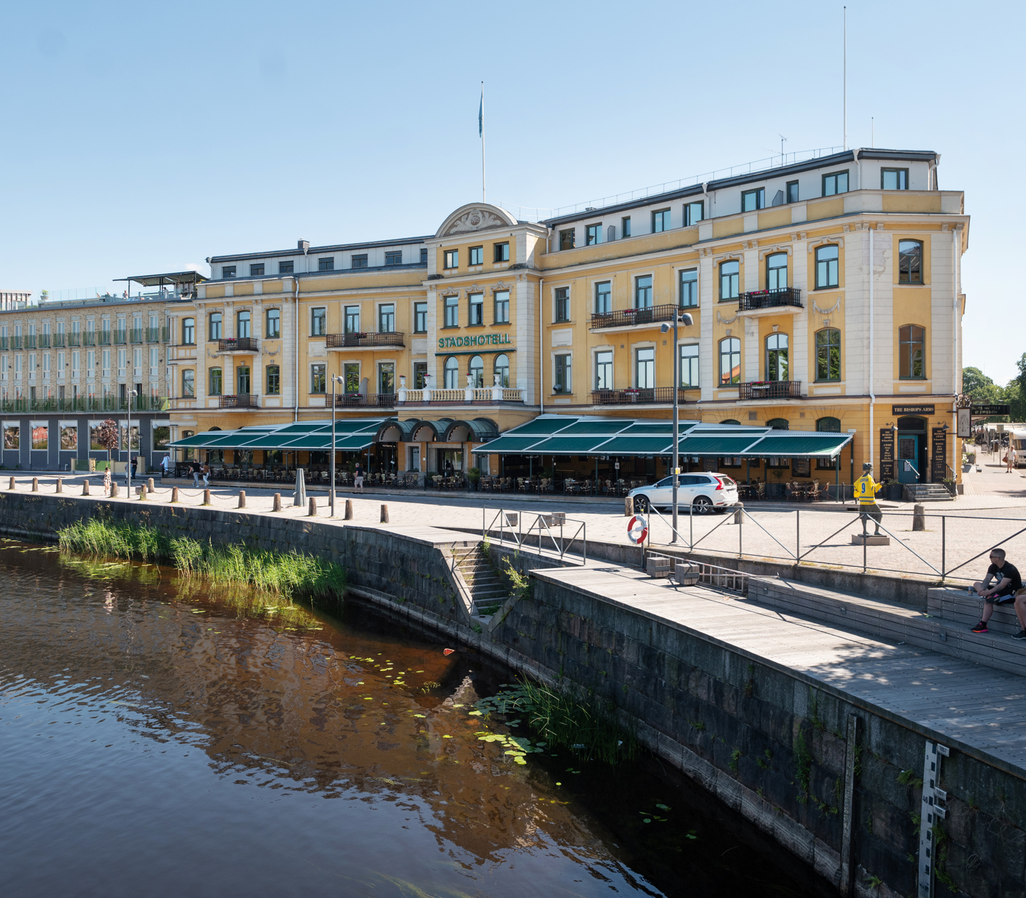 Pampiga gula fasaden av Elite Stadshotellet i Karlstad med Klarälven framför