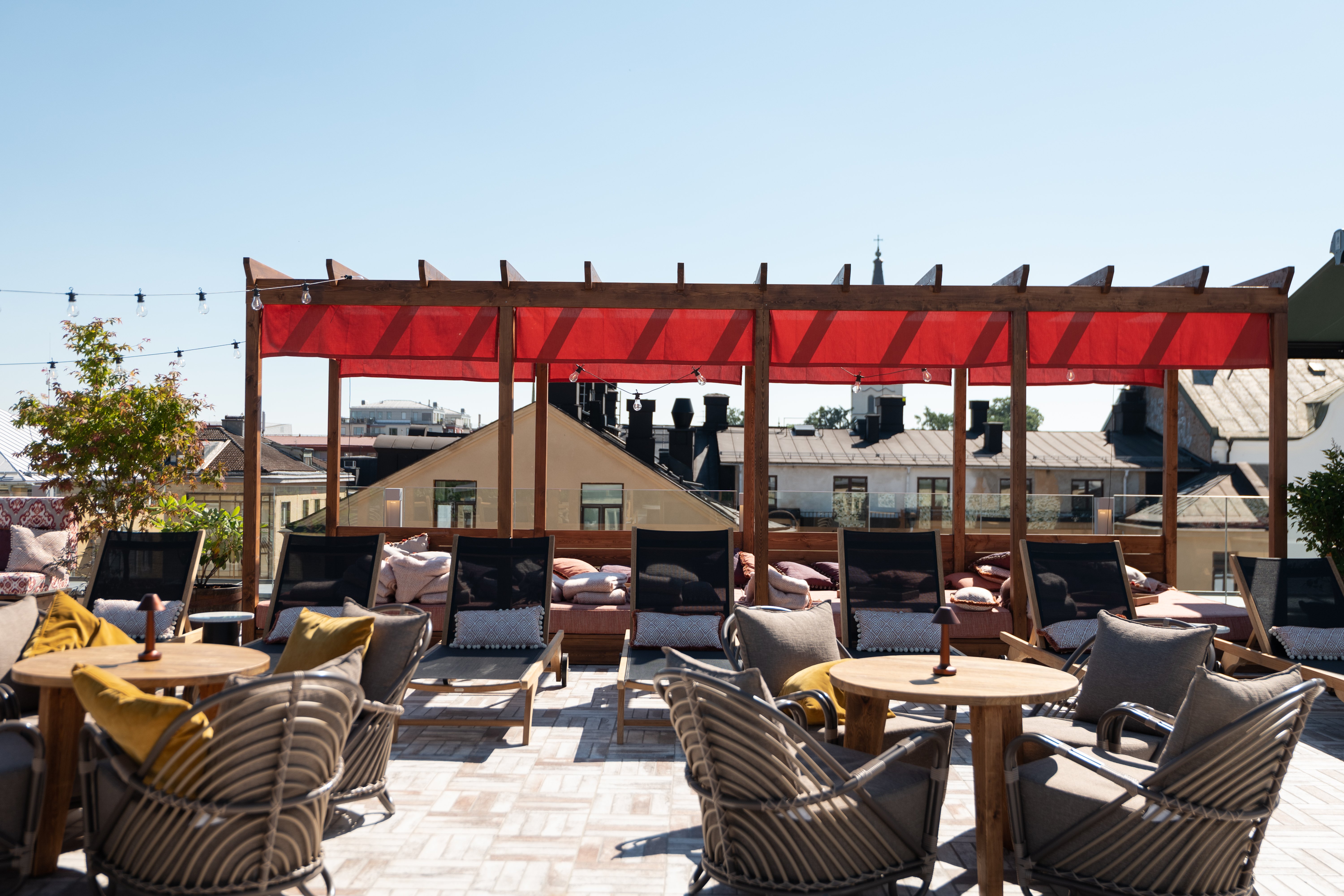 Roof terrace with sunbeds and eaves in the background