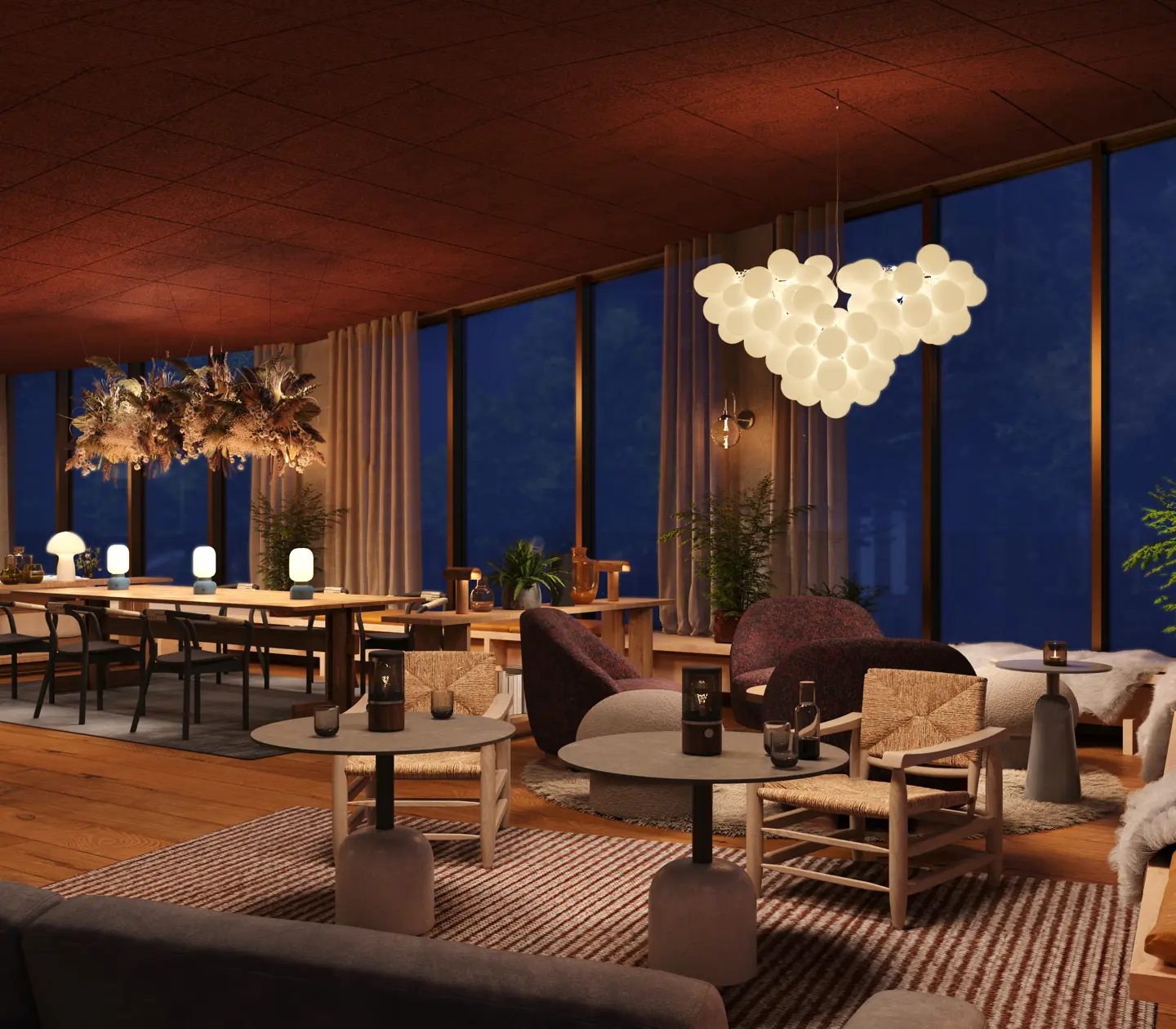 Cozy conference lobby in the evening with modern décor, elegant furniture, and ambient lighting, offering a view of the nature surroundings through large windows.