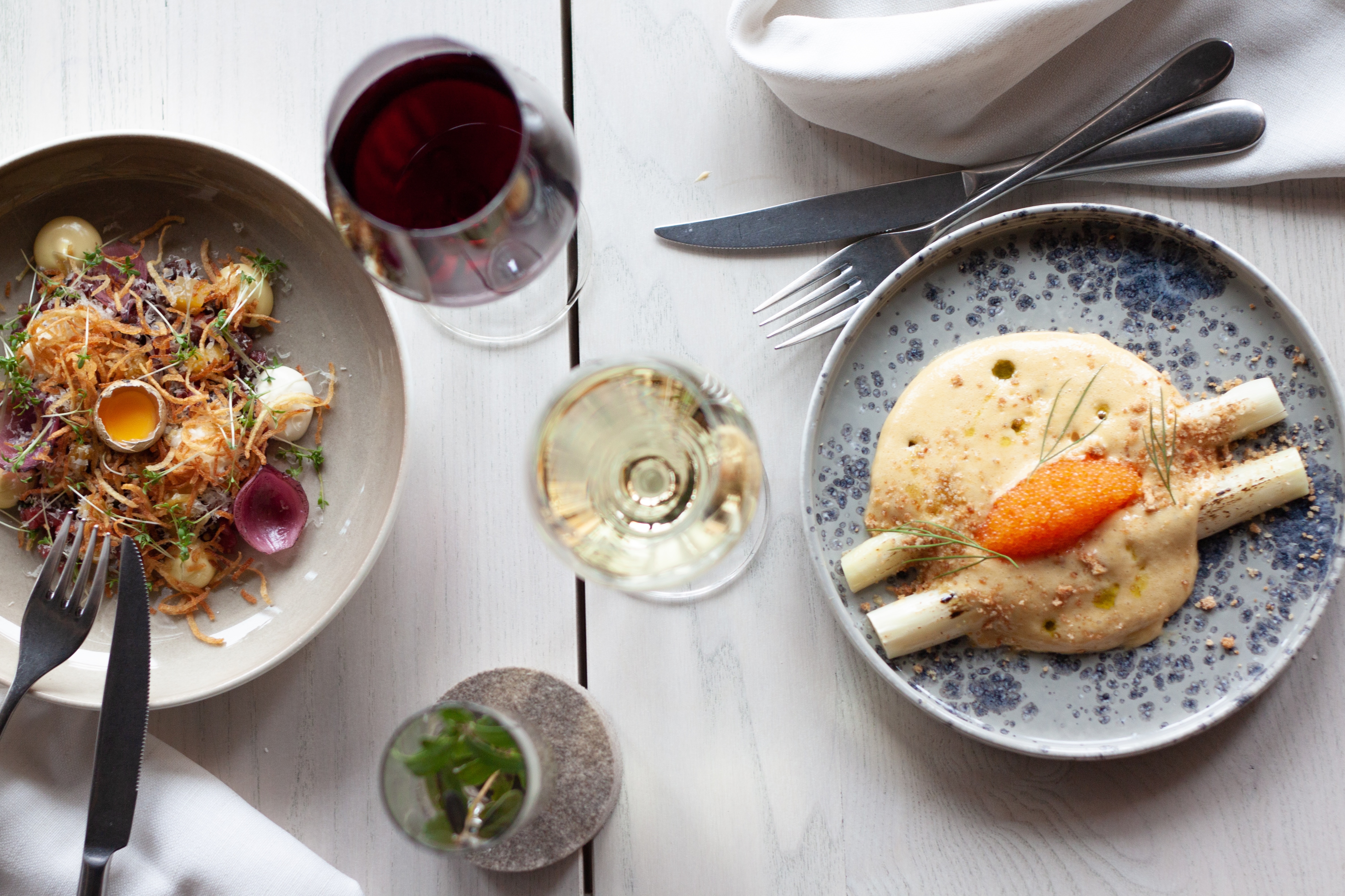 Woman and man laughing at dinner table