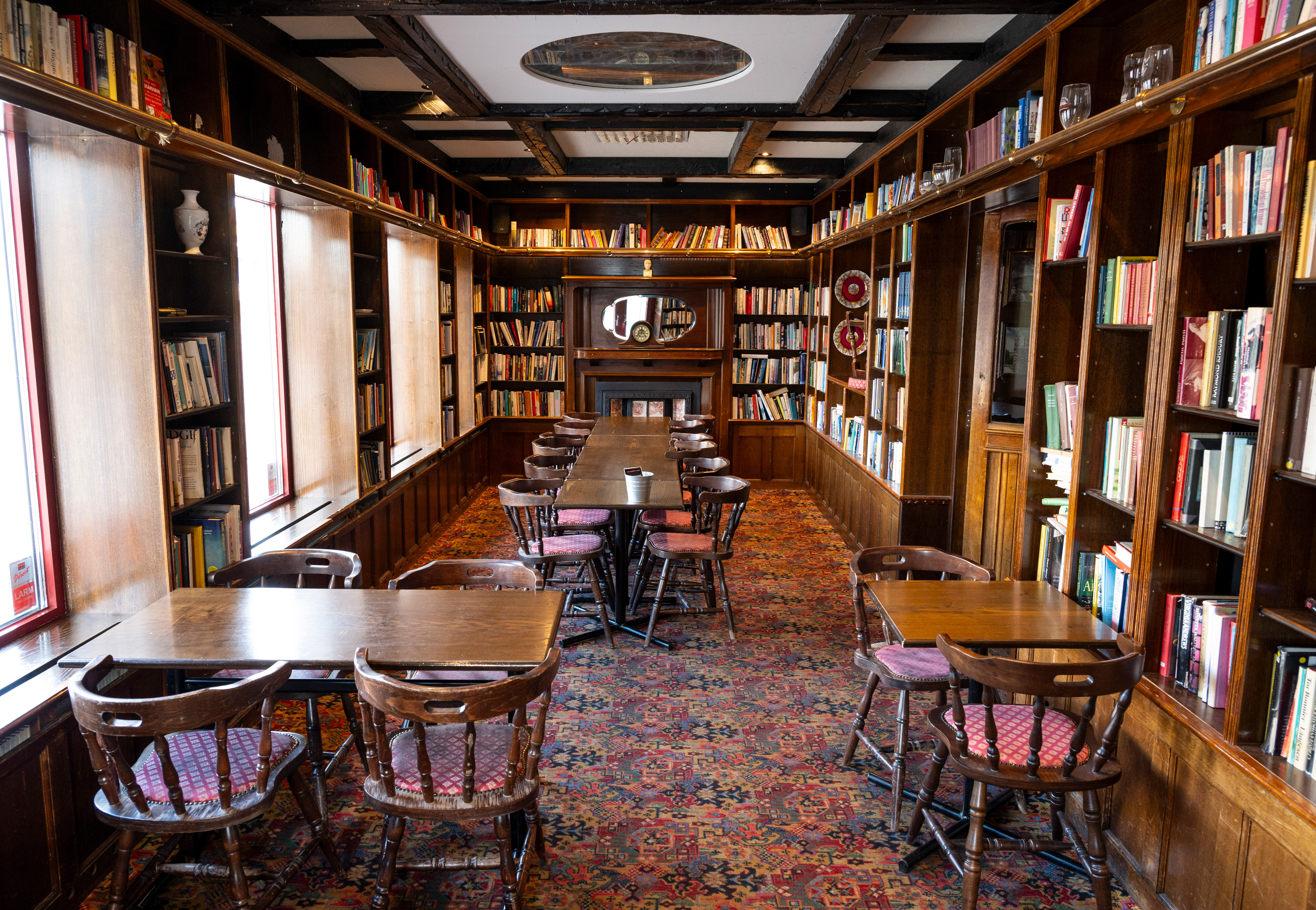 Dining room in library with books along the walls and dining table