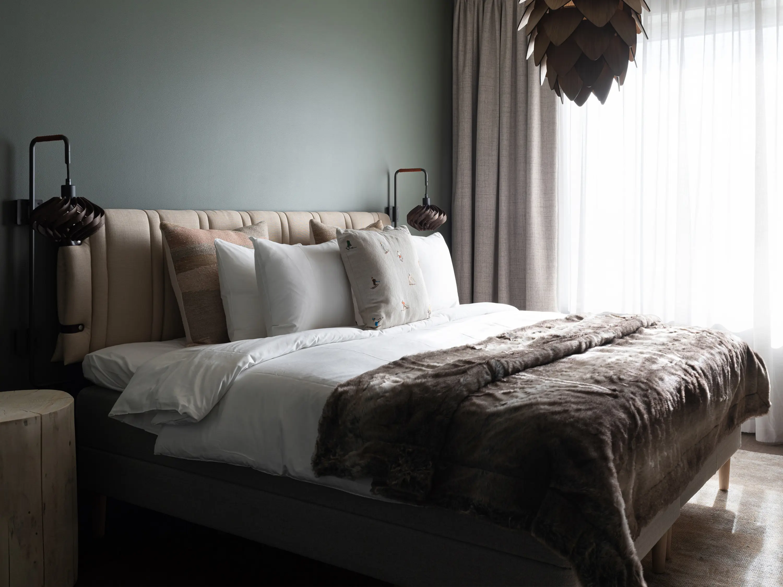 Nicely made hotel bed in a Deluxe room.