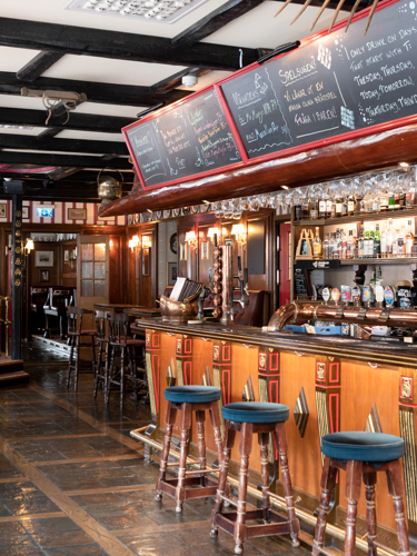 Pub environment with bar, bar stools and menus