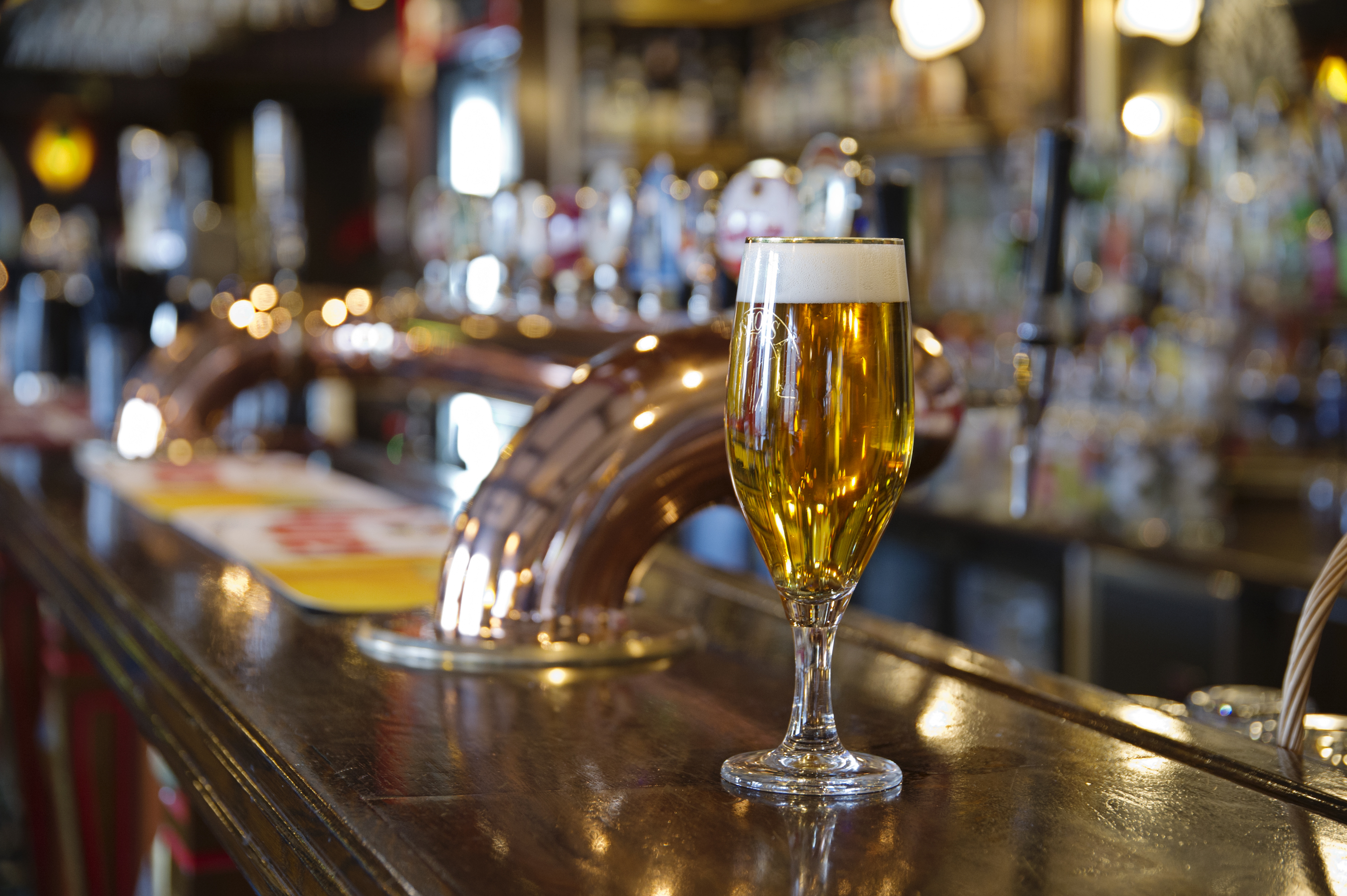 Beer glasses filled in bar counter