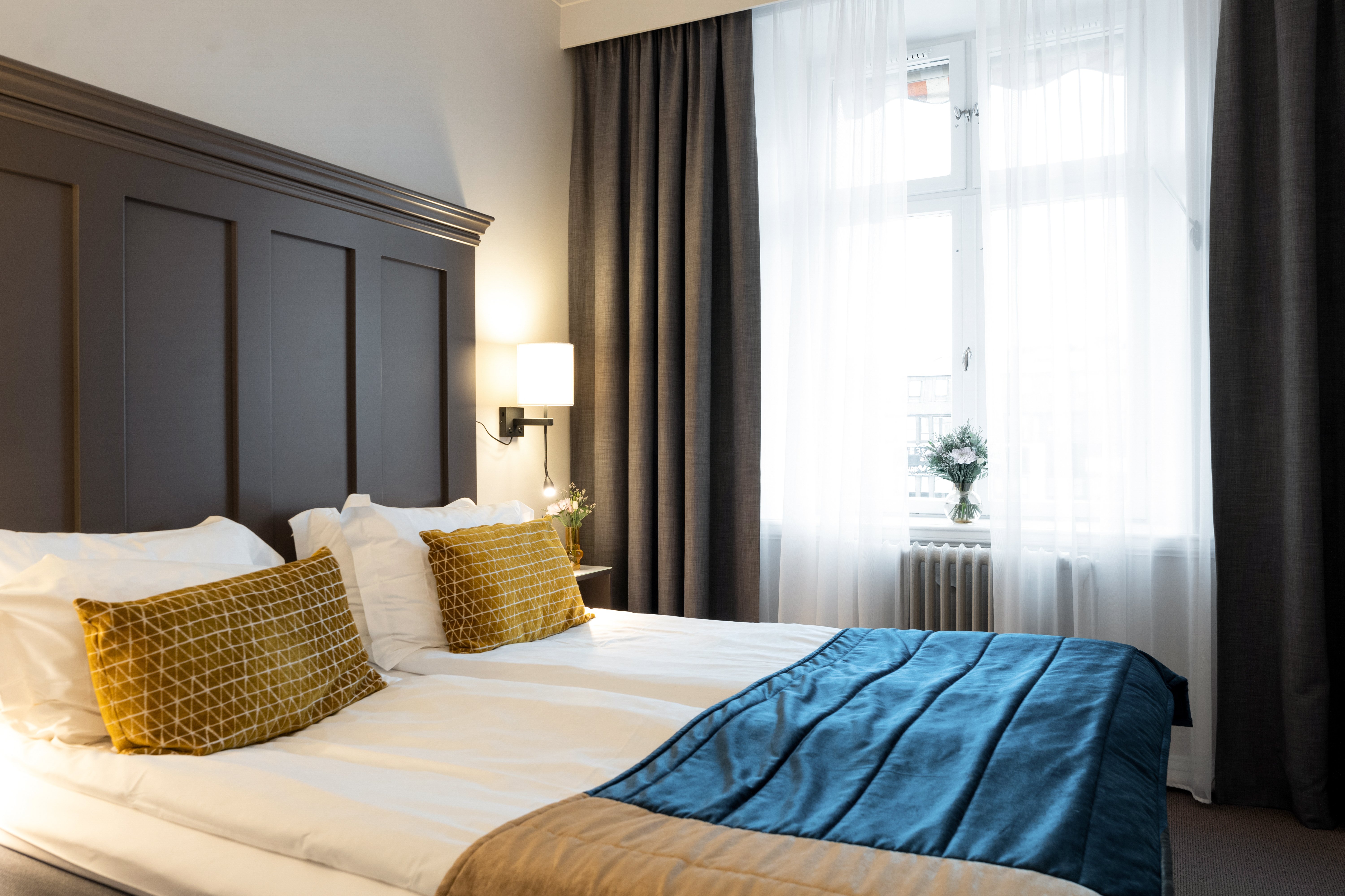 Cozy hotel room with part of a double bed and large window