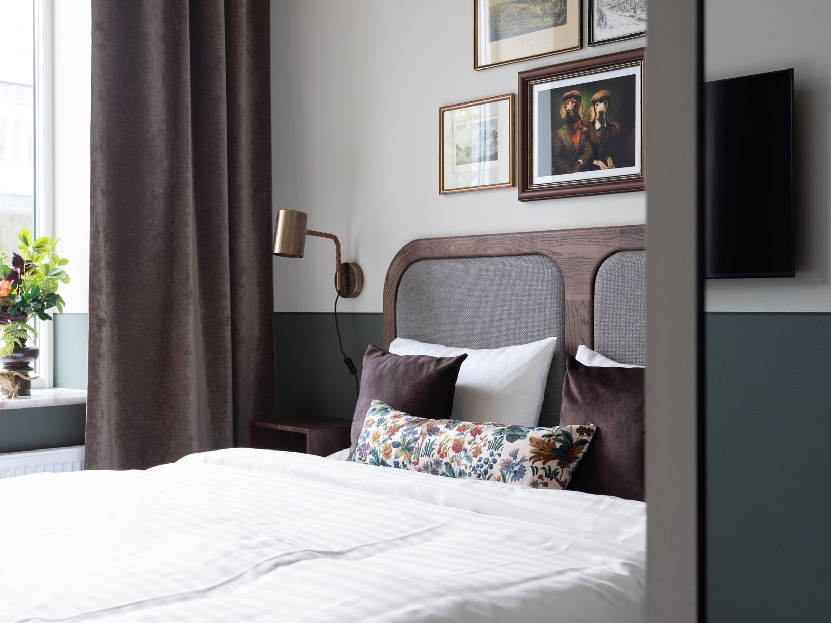 Bright hotel room with bed, window and bedside lamps