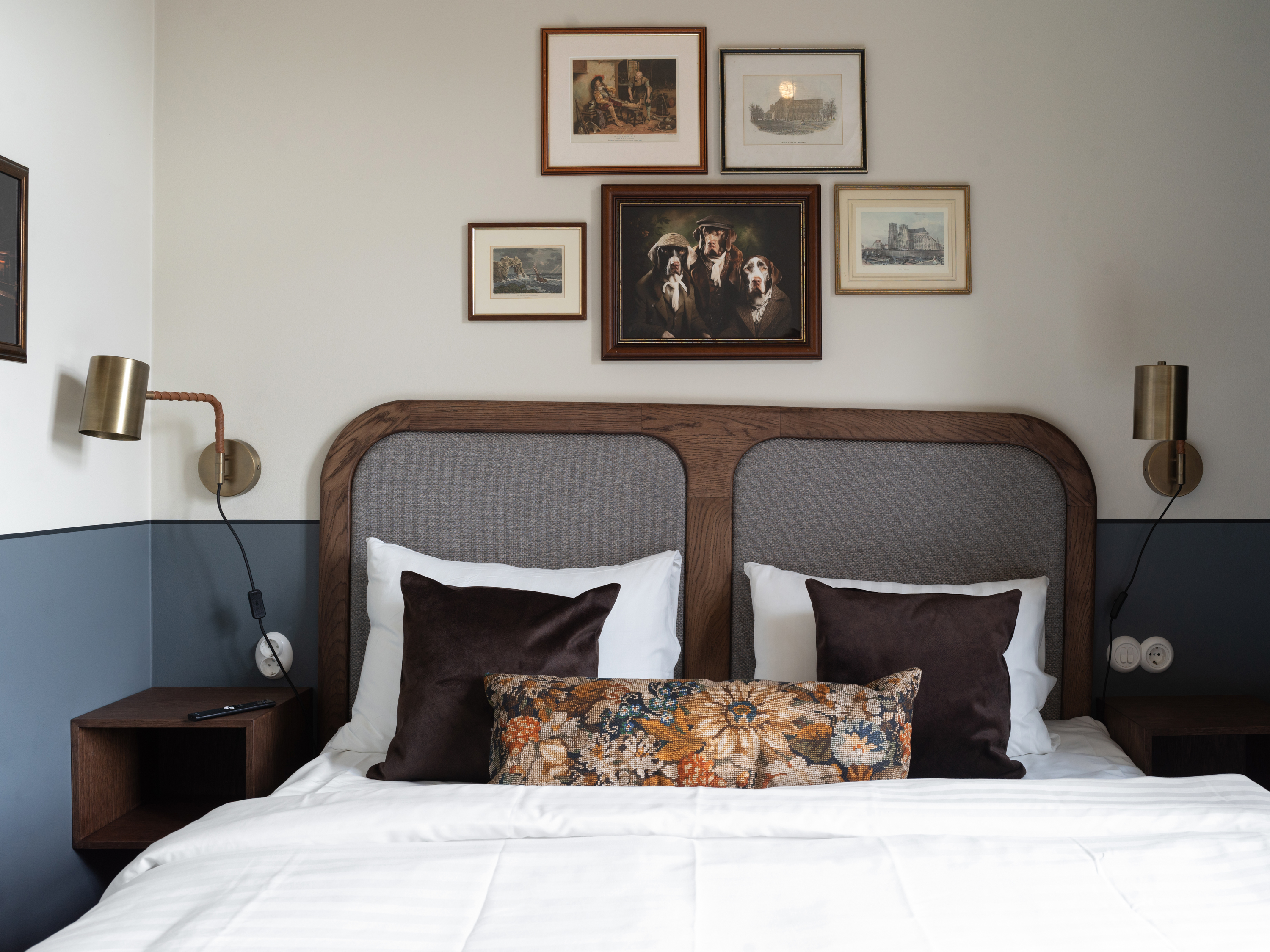 Ljus och modern sovrum med bekväm säng, kuddar med färgglada prickar, nattduksbord och belysning, naturligt ljus genom stora fönster med gardiner.