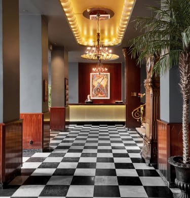 Hotel reception with checkered floor and palm tree