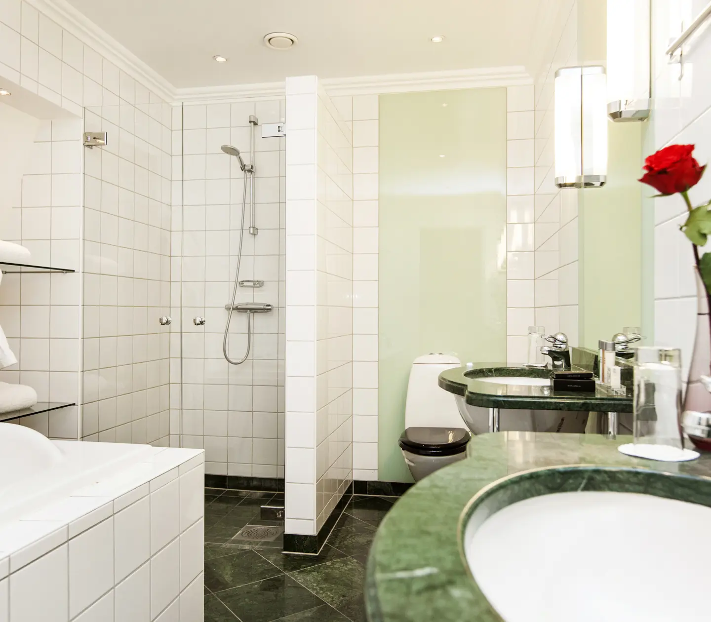 Bathroom with two sinks, toilet and shower
