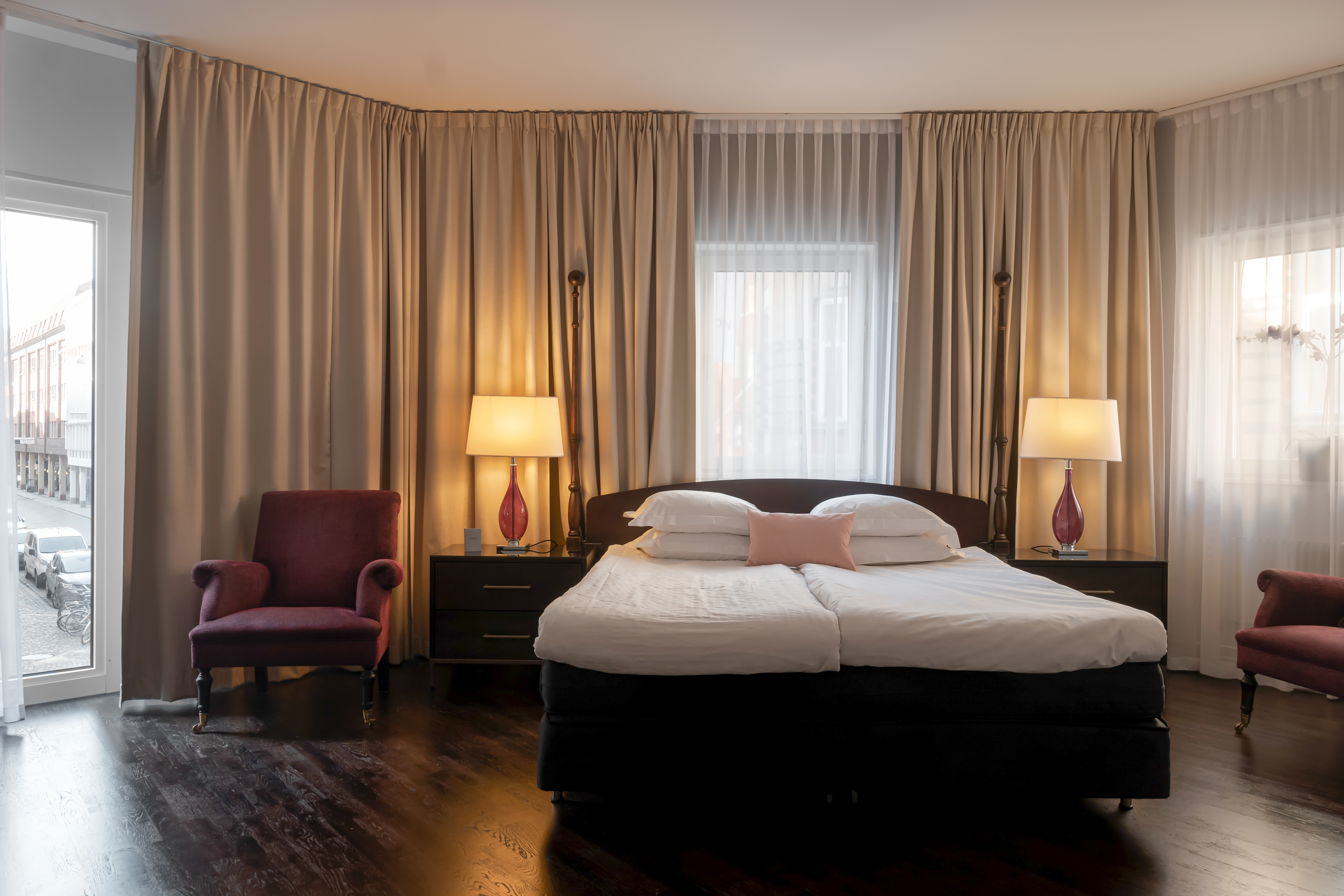 Cozy hotel room with bed, window and curtains