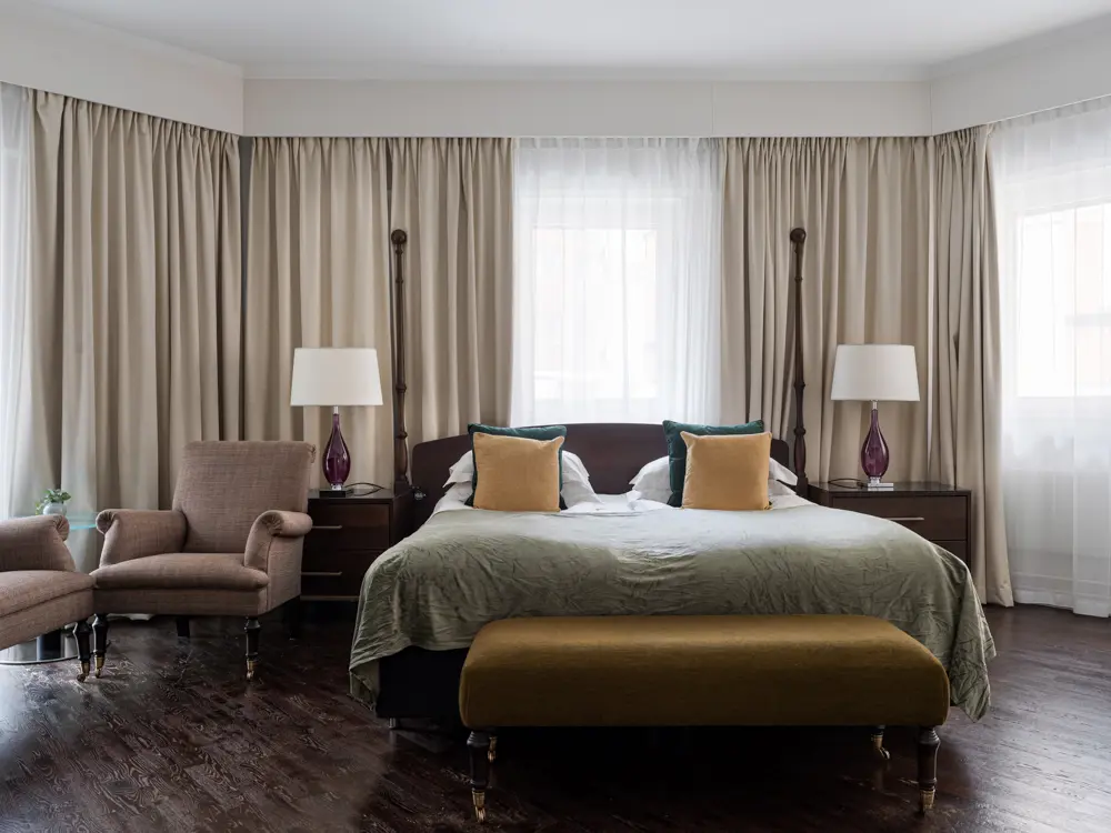 Cozy hotel room with bed, window and curtains