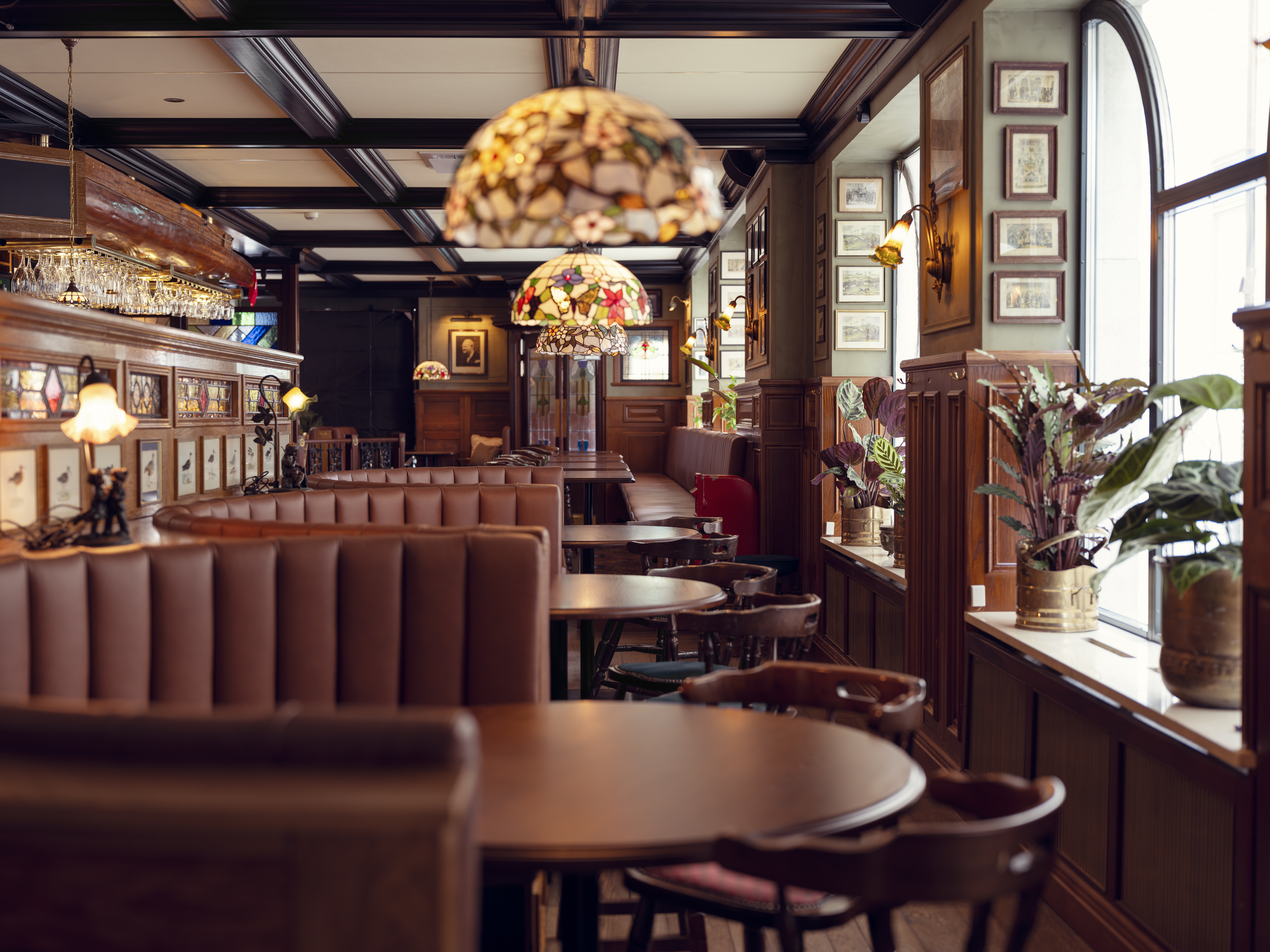 Cozy restaurant interior with wooden tables and booths.