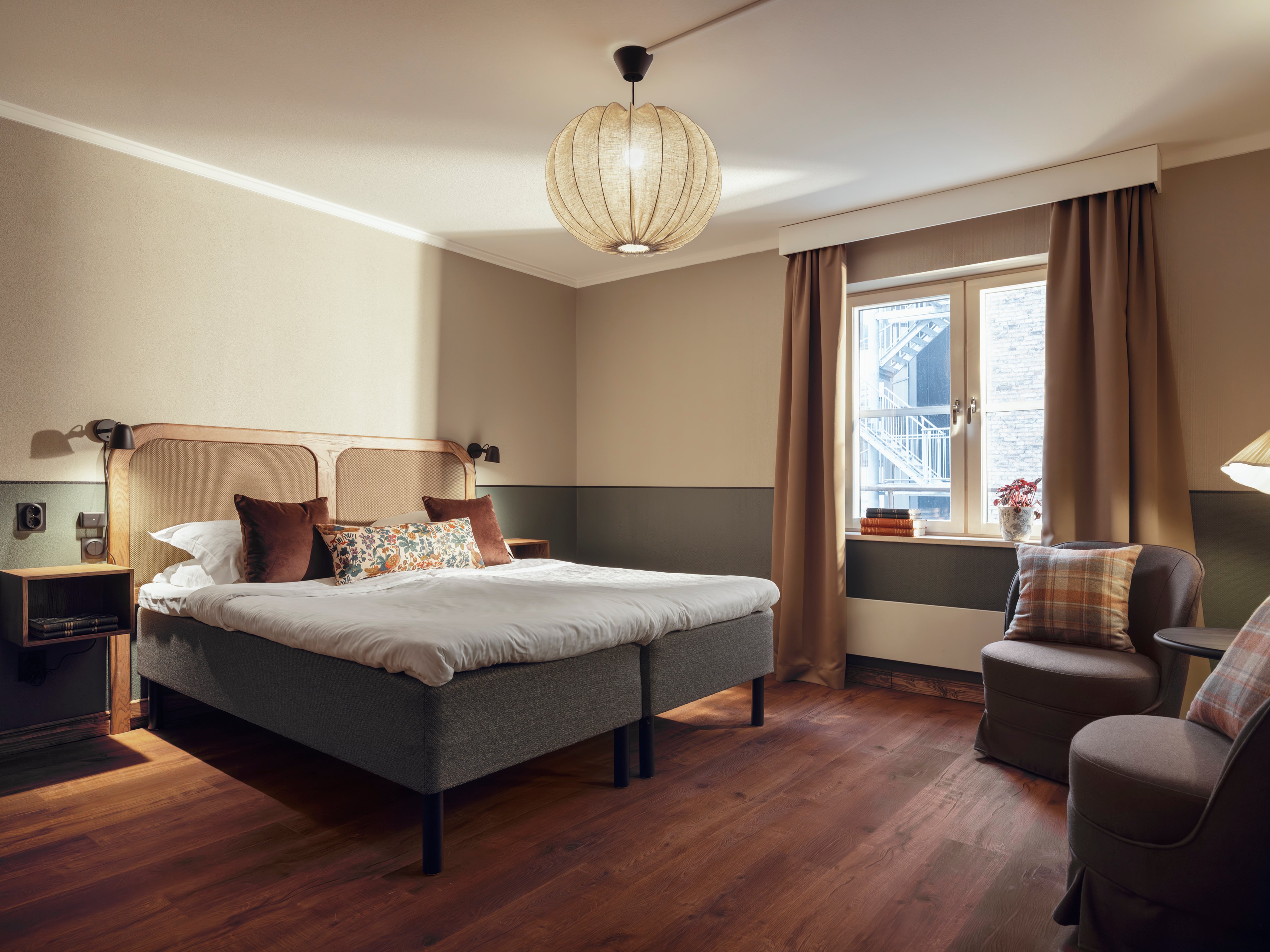 Cozy bedroom with a double bed, window, and warm lighting.