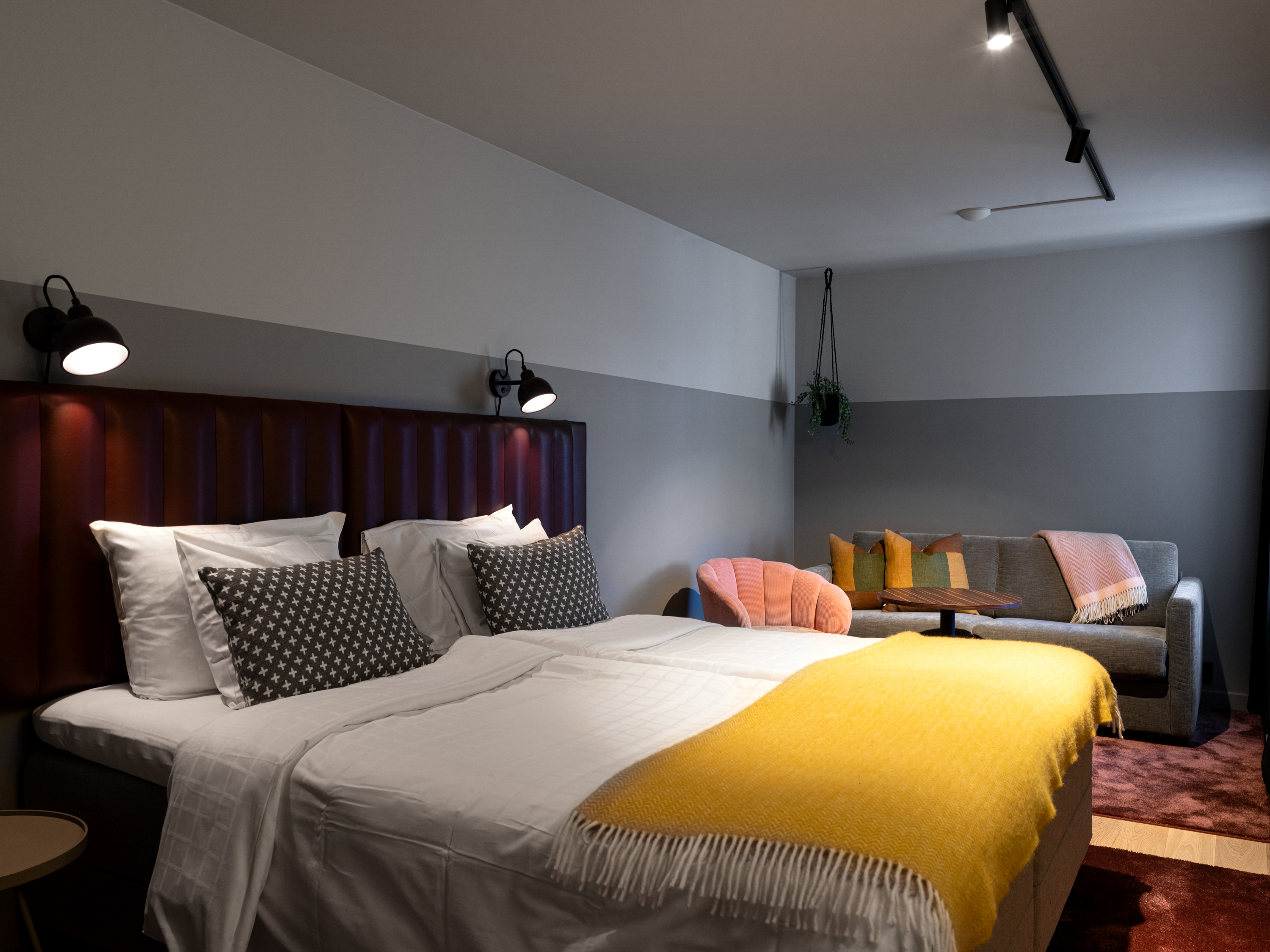 Cozy hotel room with double bed and sofa group