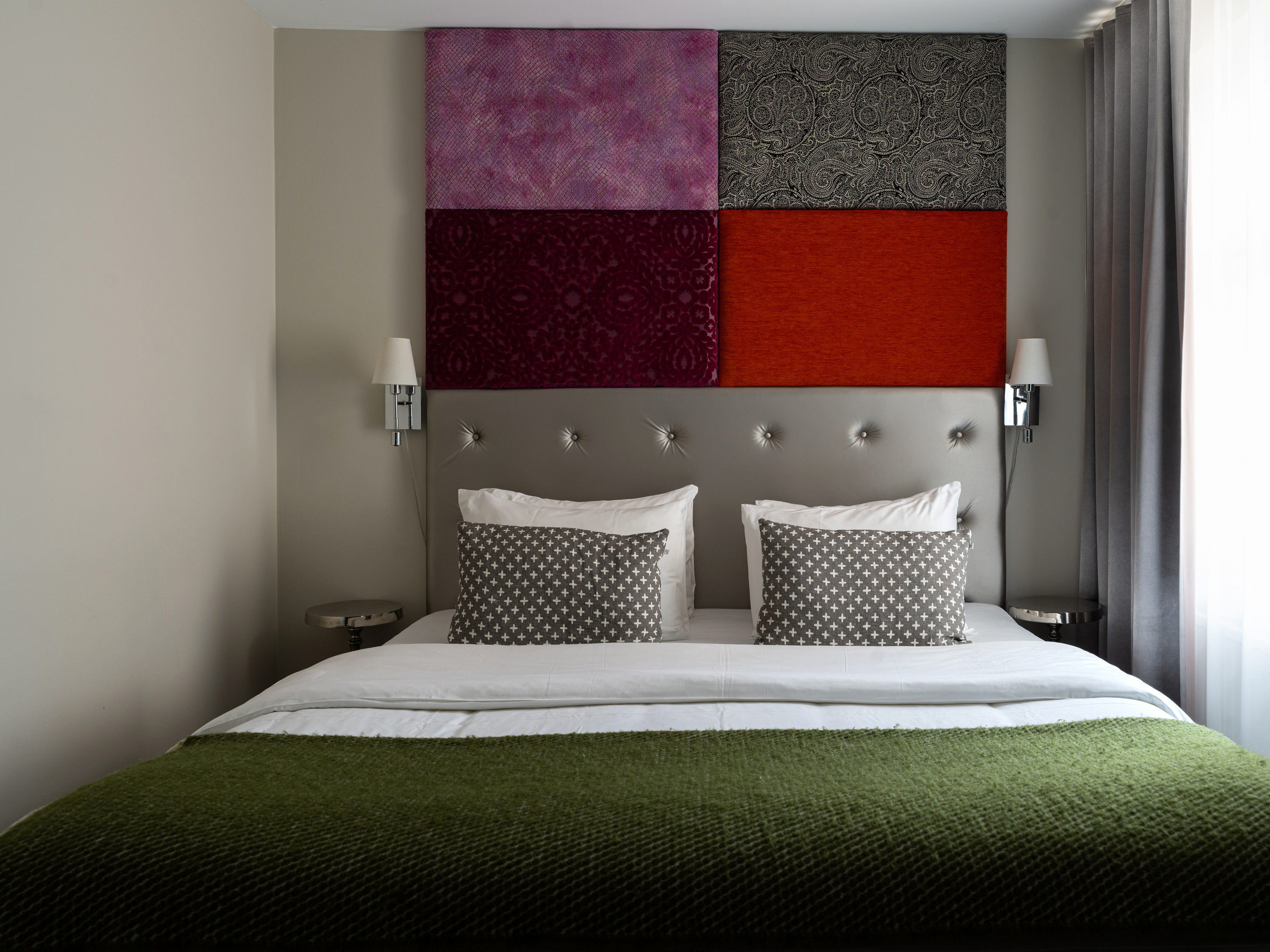 Hotel room with double bed and colorful headboard