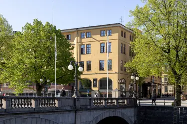 Yellow building behind a little bridge