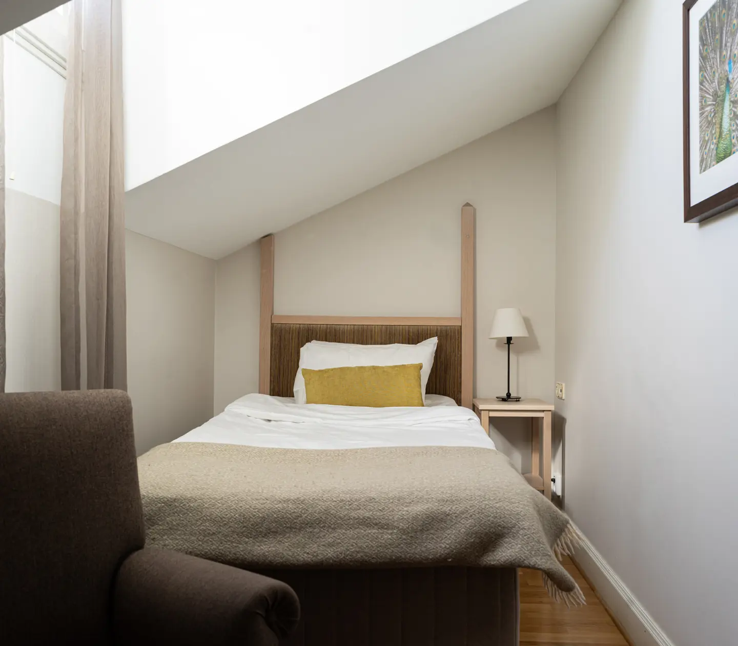 Cozy single room with small bedside table and single bed
