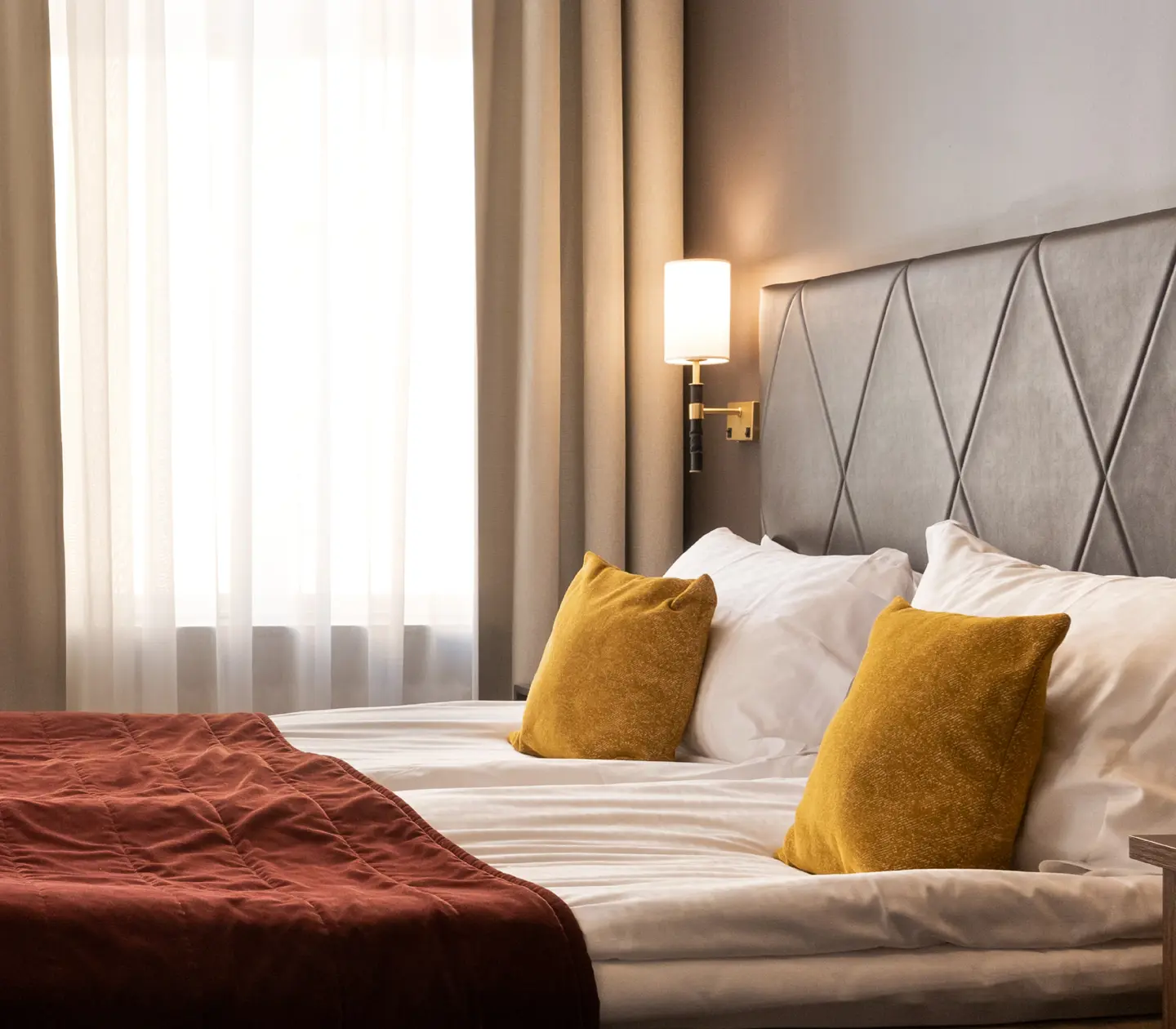 Hotel room with desk, TV, armchair and wardrobe