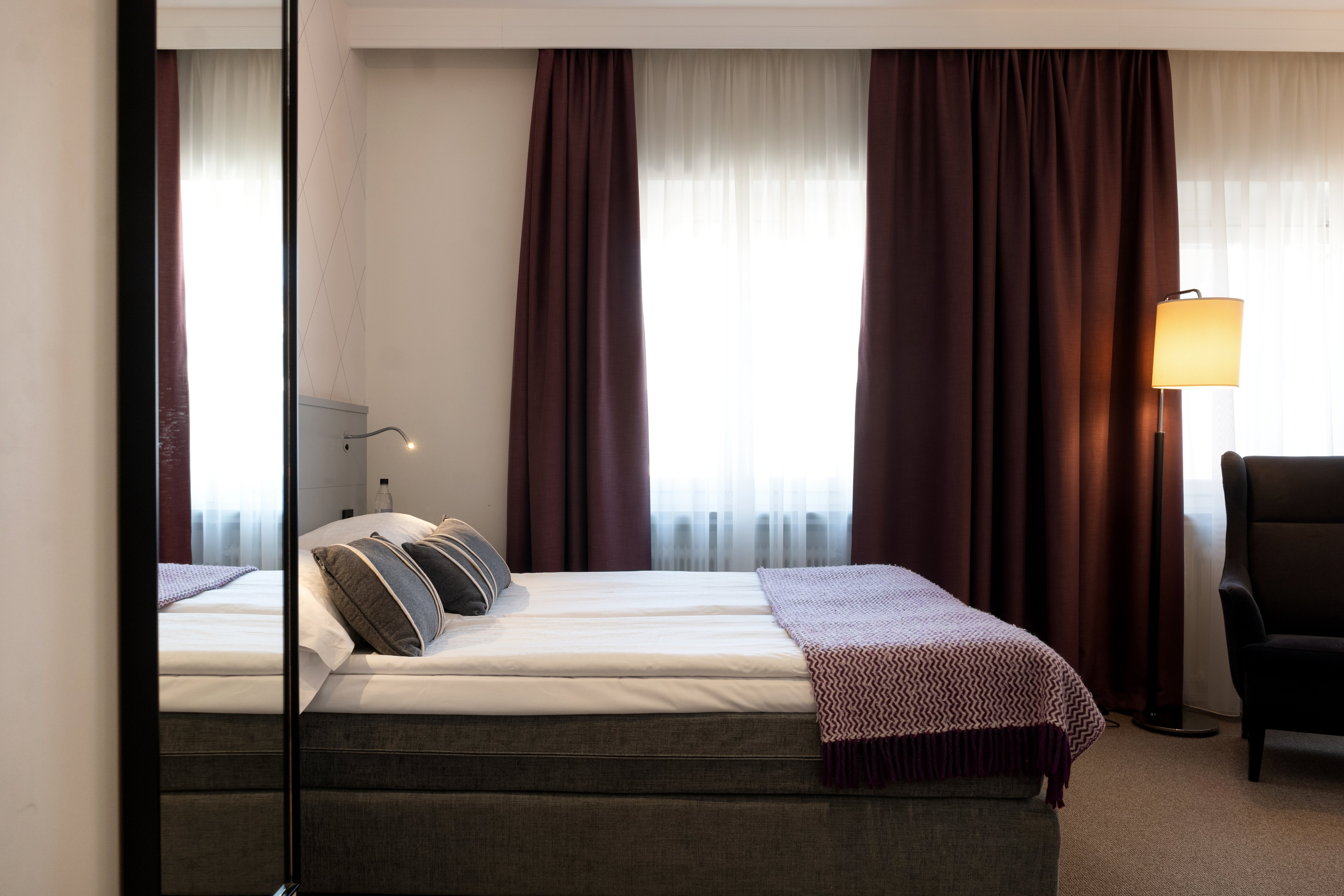 Hotel room with double bed, armchair and window