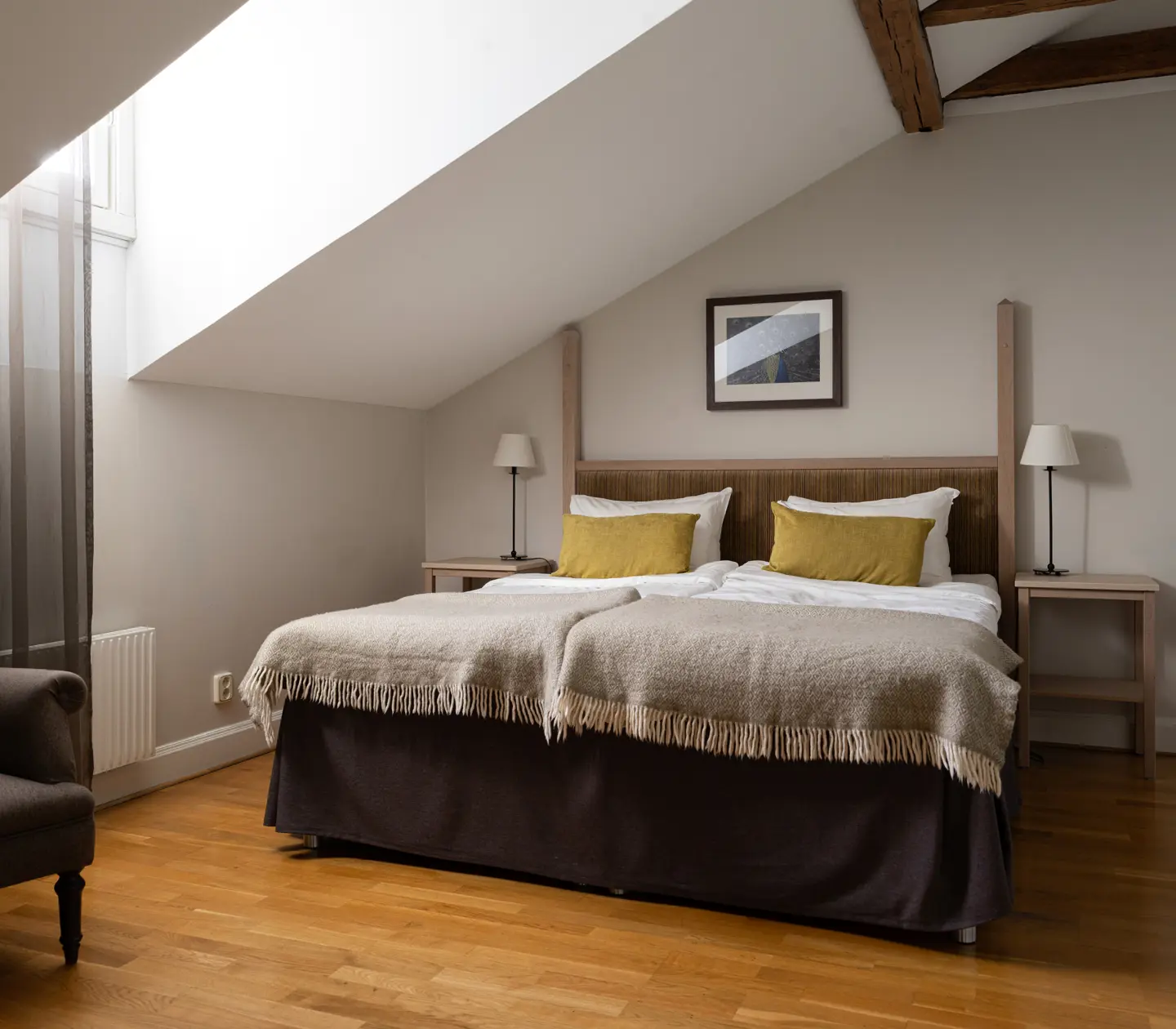 Hotel room with double bed, armchairs and window