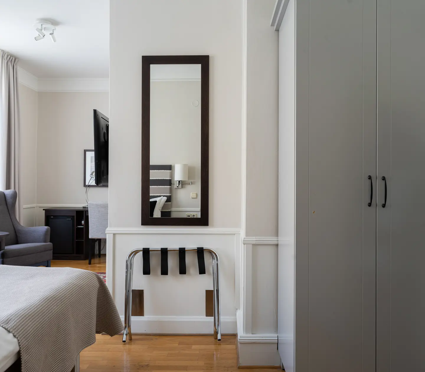 Hotel room with double bed, armchair and window