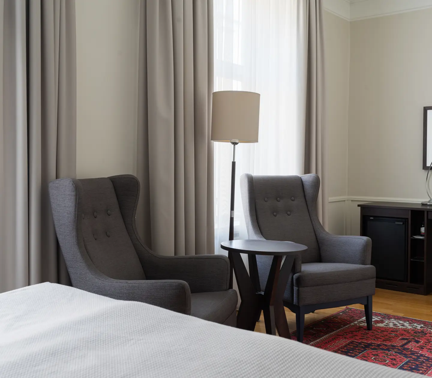 Hotel room with double bed, armchair and window
