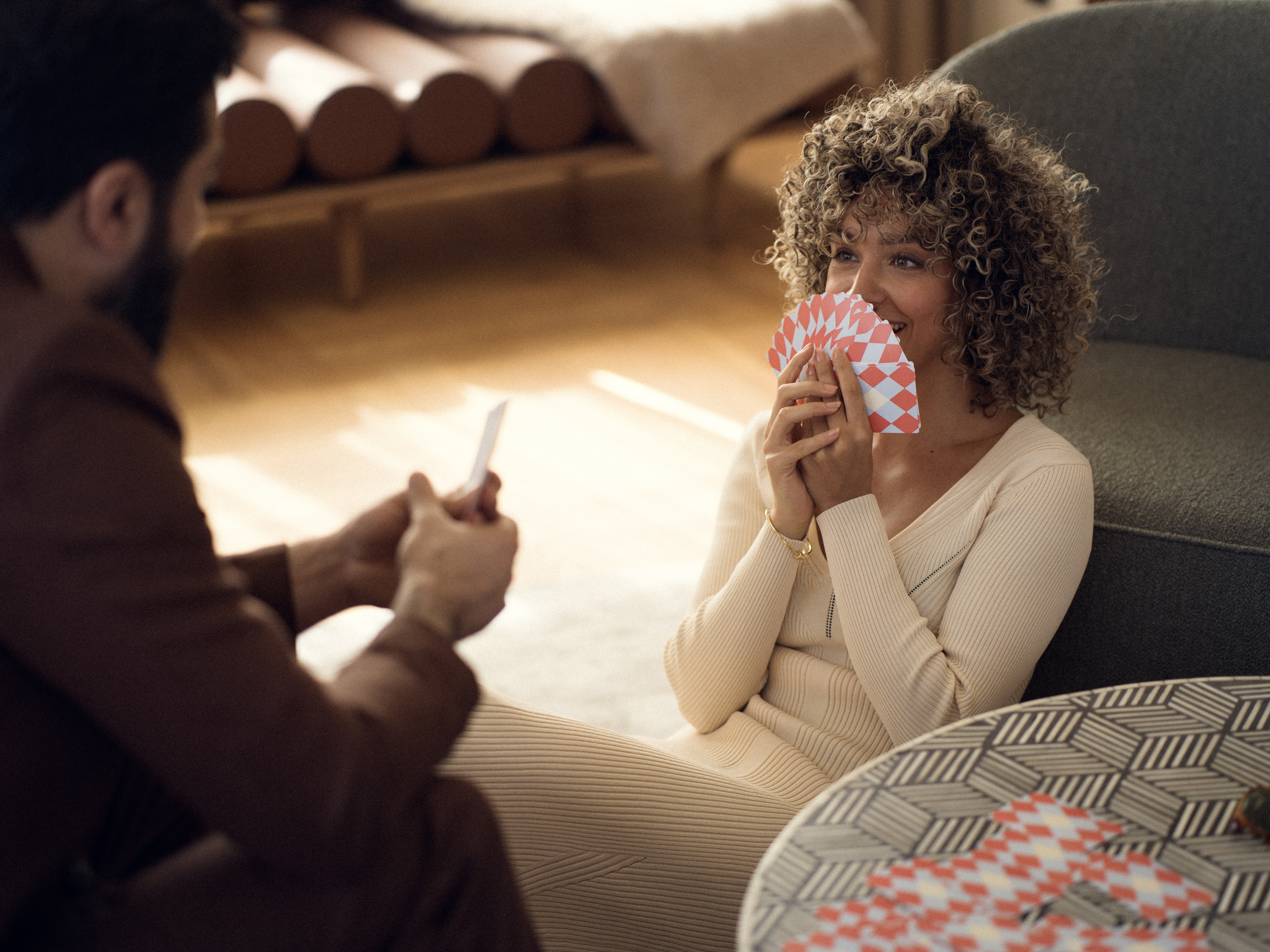 Couple playing cards in a beautiful hotel room