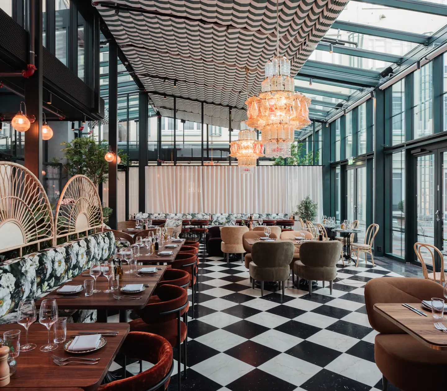 Restaurant environment with checkerboard floor, dining groups and large windows