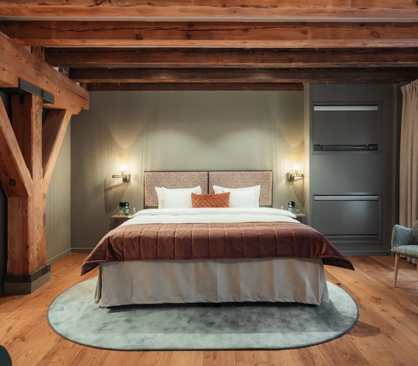 Cozy hotel room with wooden beams in the ceiling, hotel bed and window