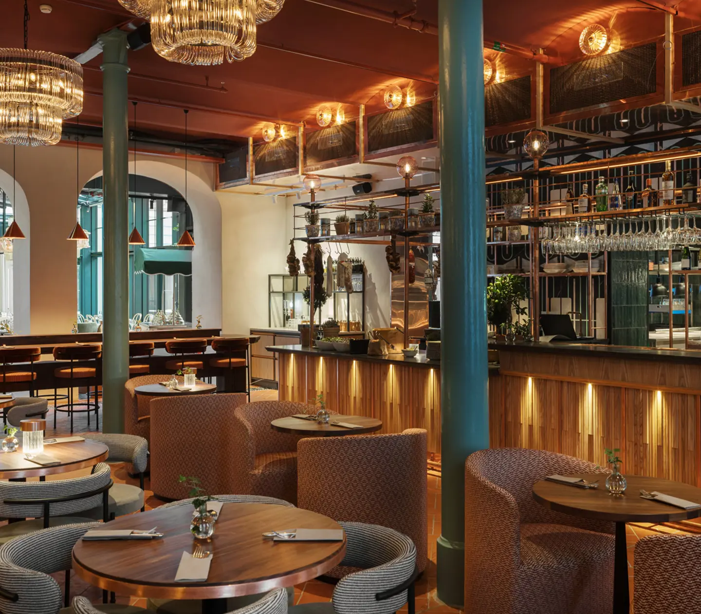 Restaurant environment with bar, dining groups and ceiling lights