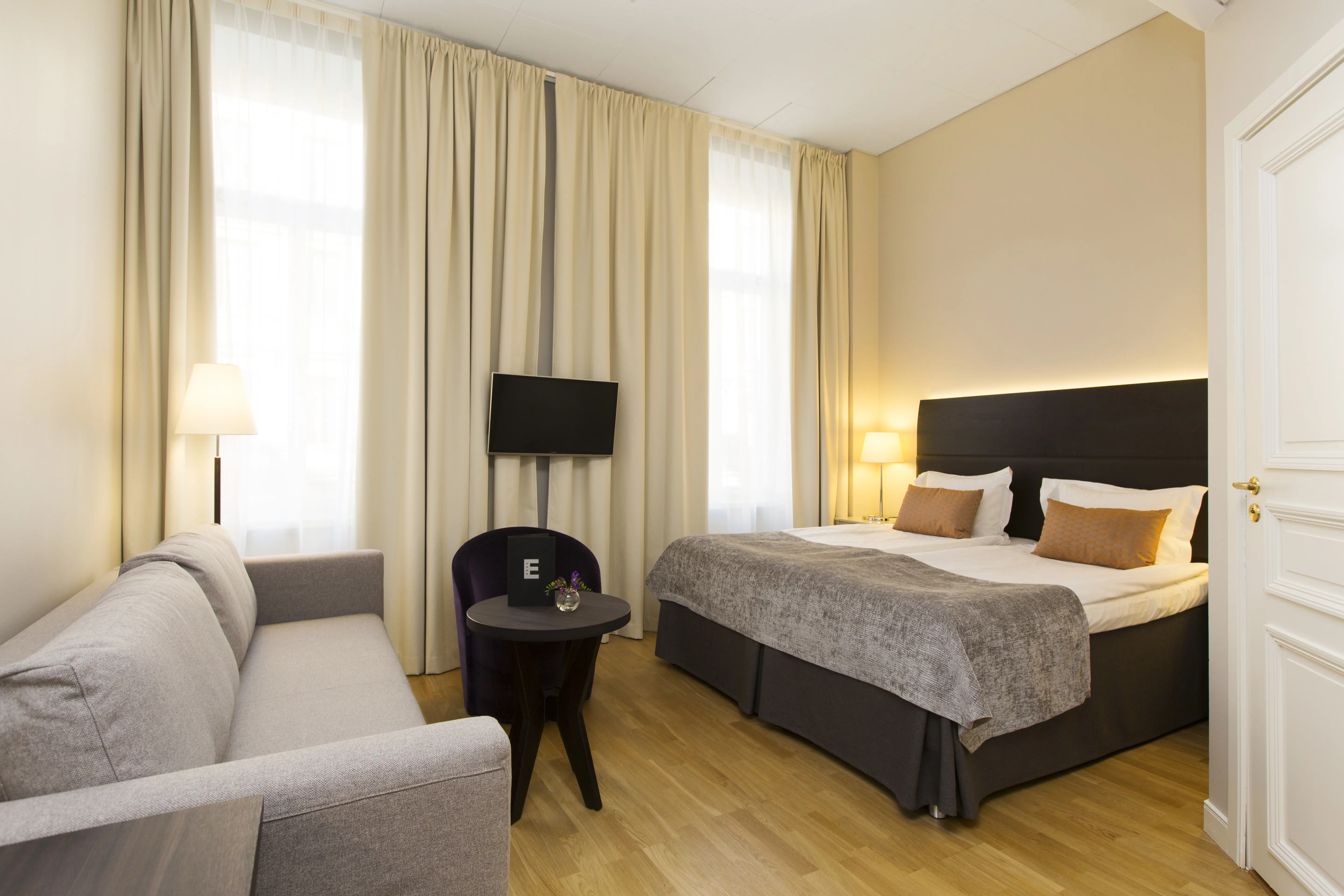 Room with double bed and sofa