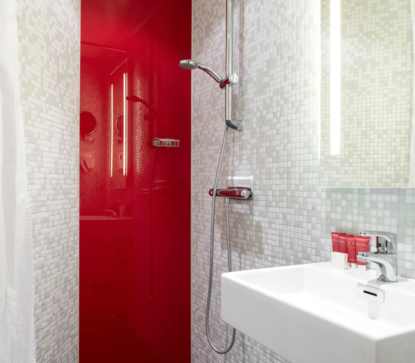 Red bathroom with shower, sink and mirror