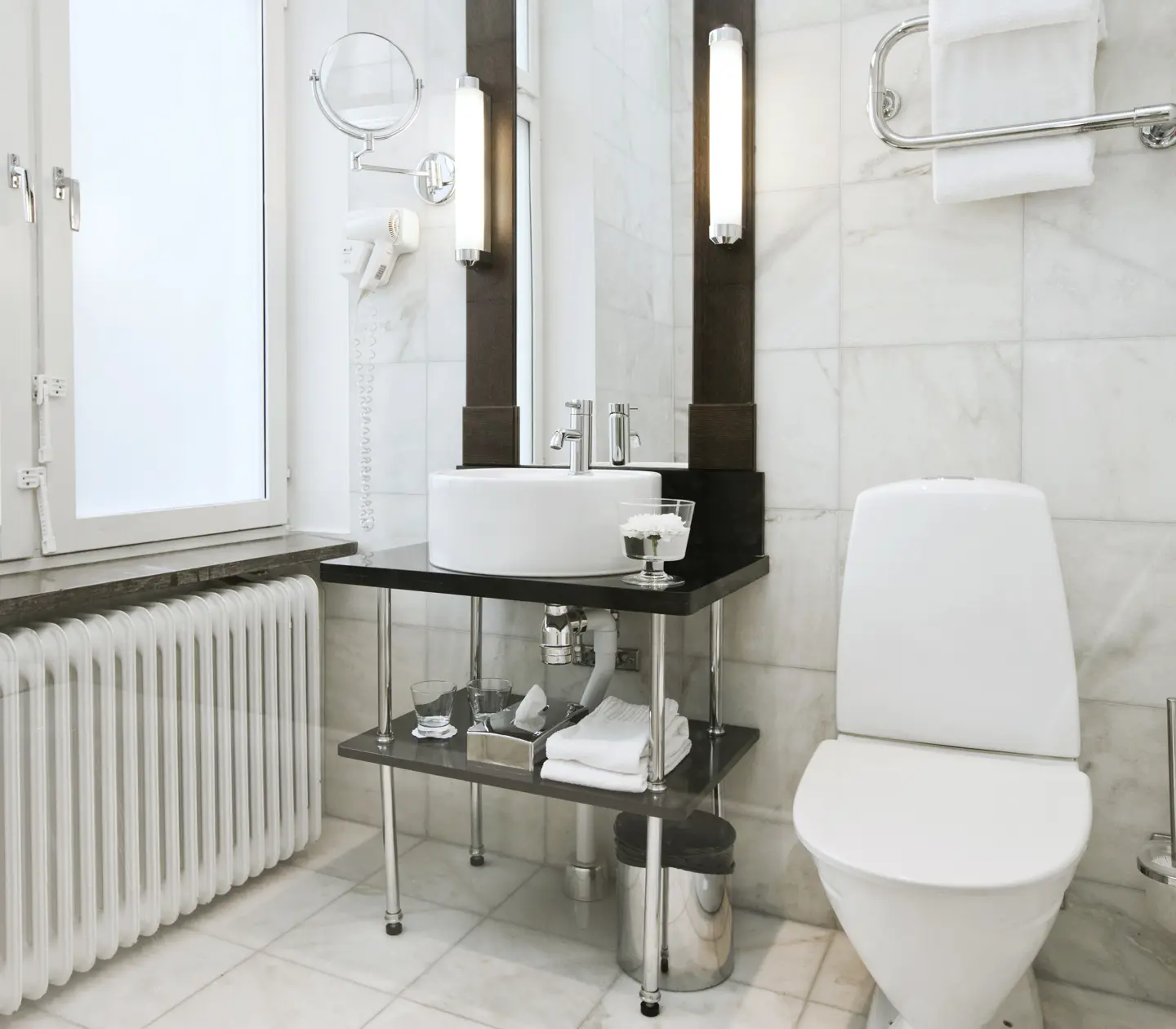 Bright bathroom with toilet, sink and window