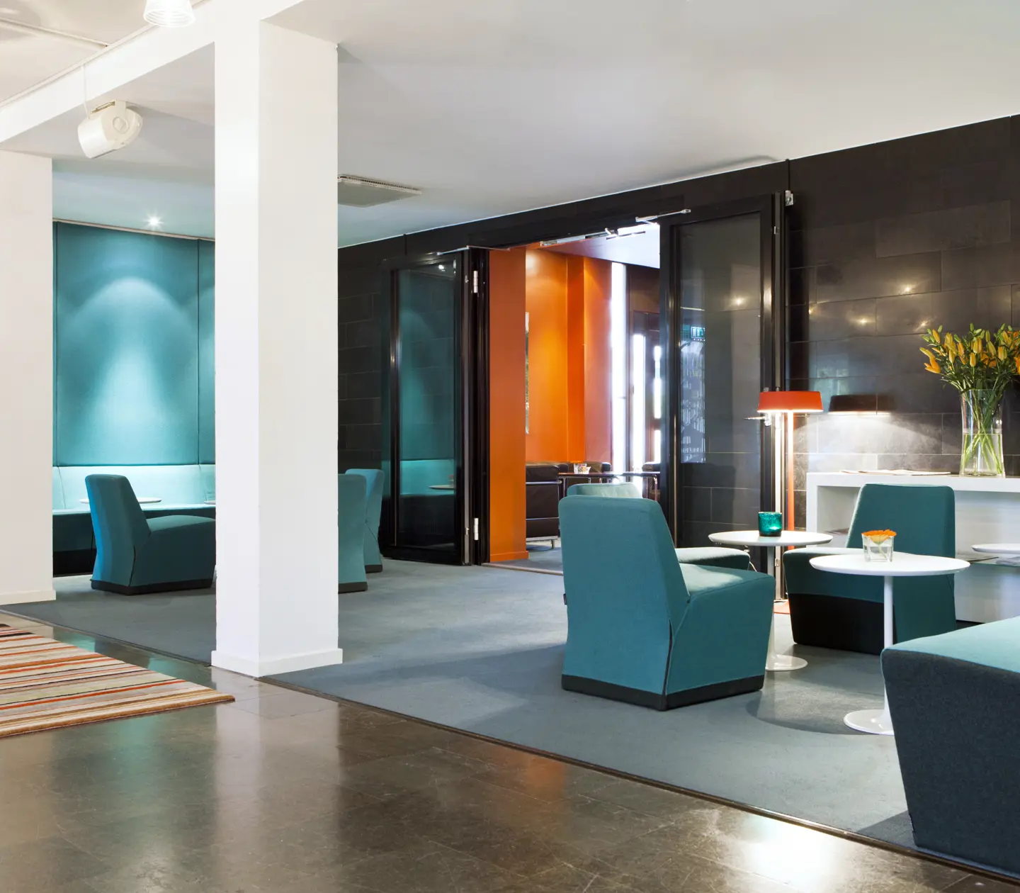 Hotel lobby with lounge furniture, carpets and bouquet